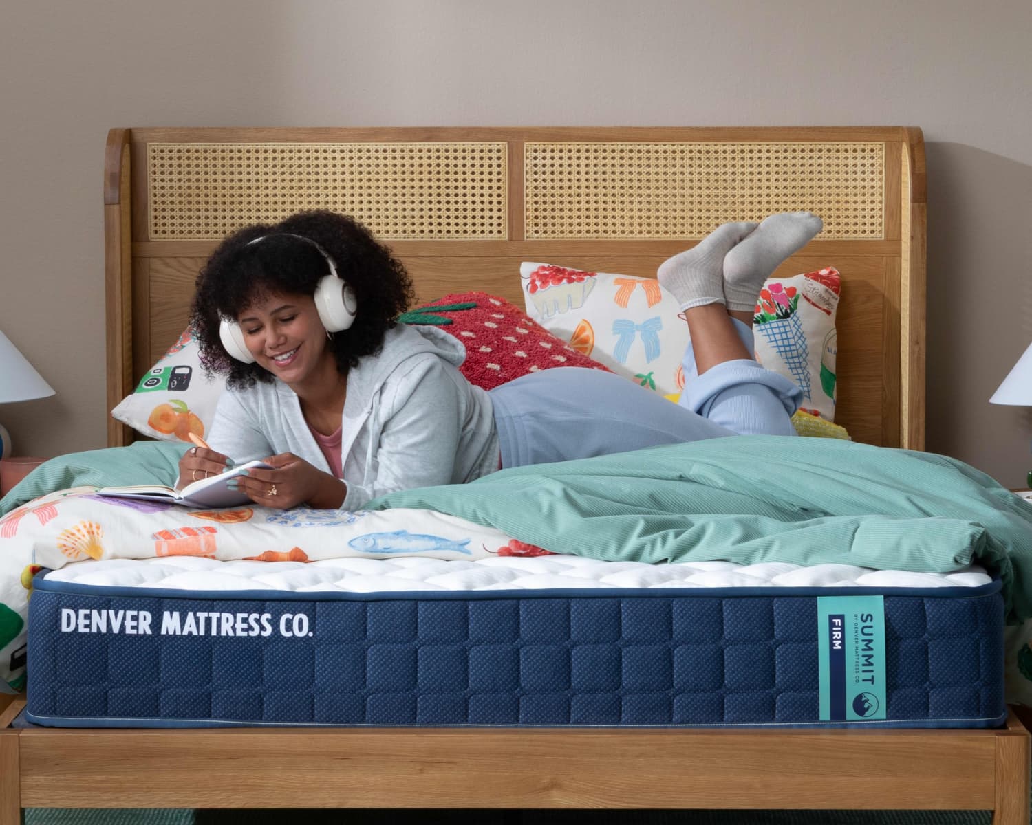Woman Laying on Summit Firm Mattress in Bedroom Writing and Listening to Music