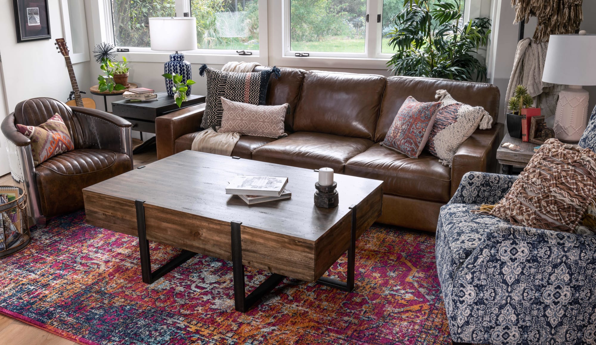 Brown leather sofa with brown leather club chair and coffee table in living room window shot