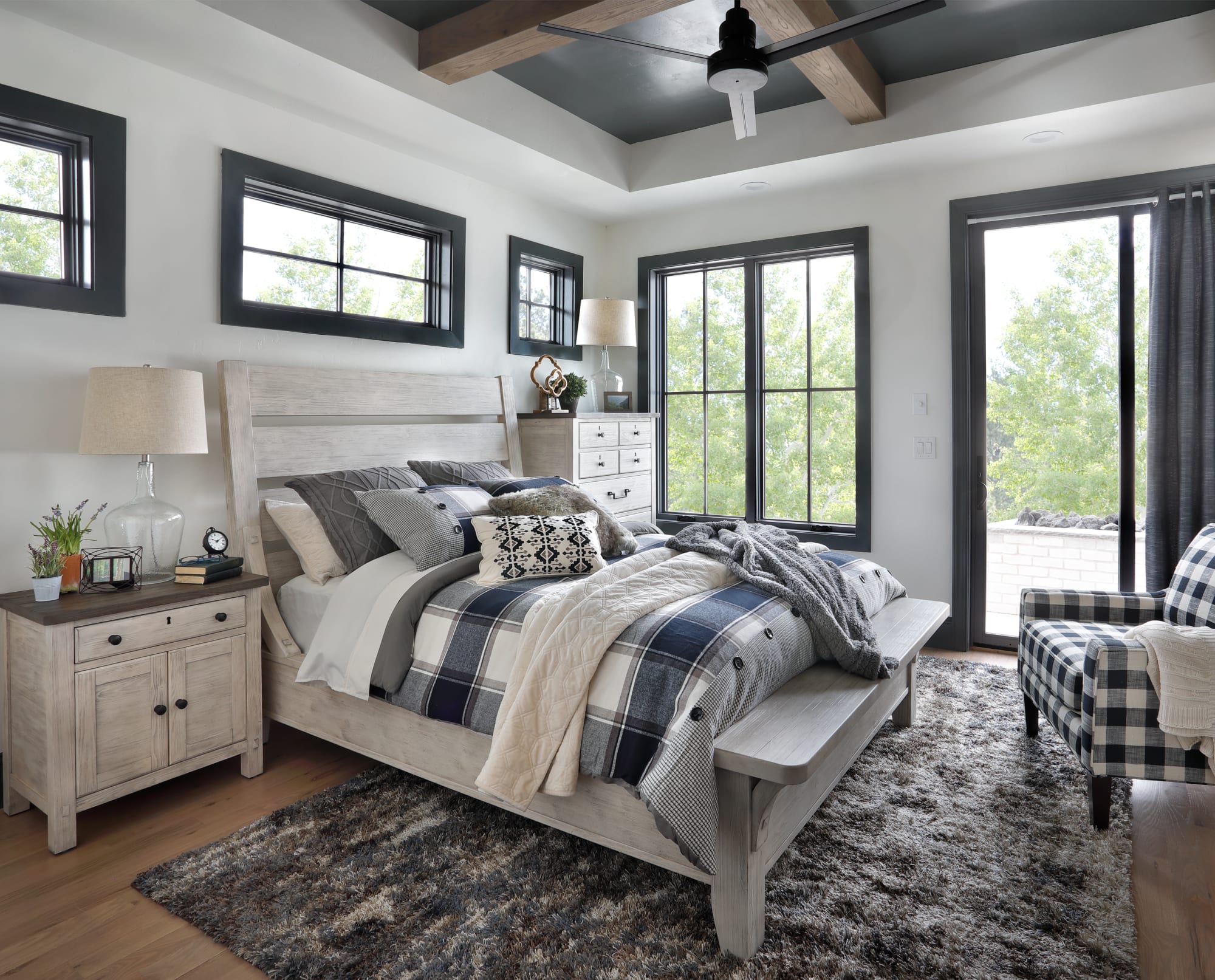 Distressed white panel bed frame with slatted headboard and matching side table.