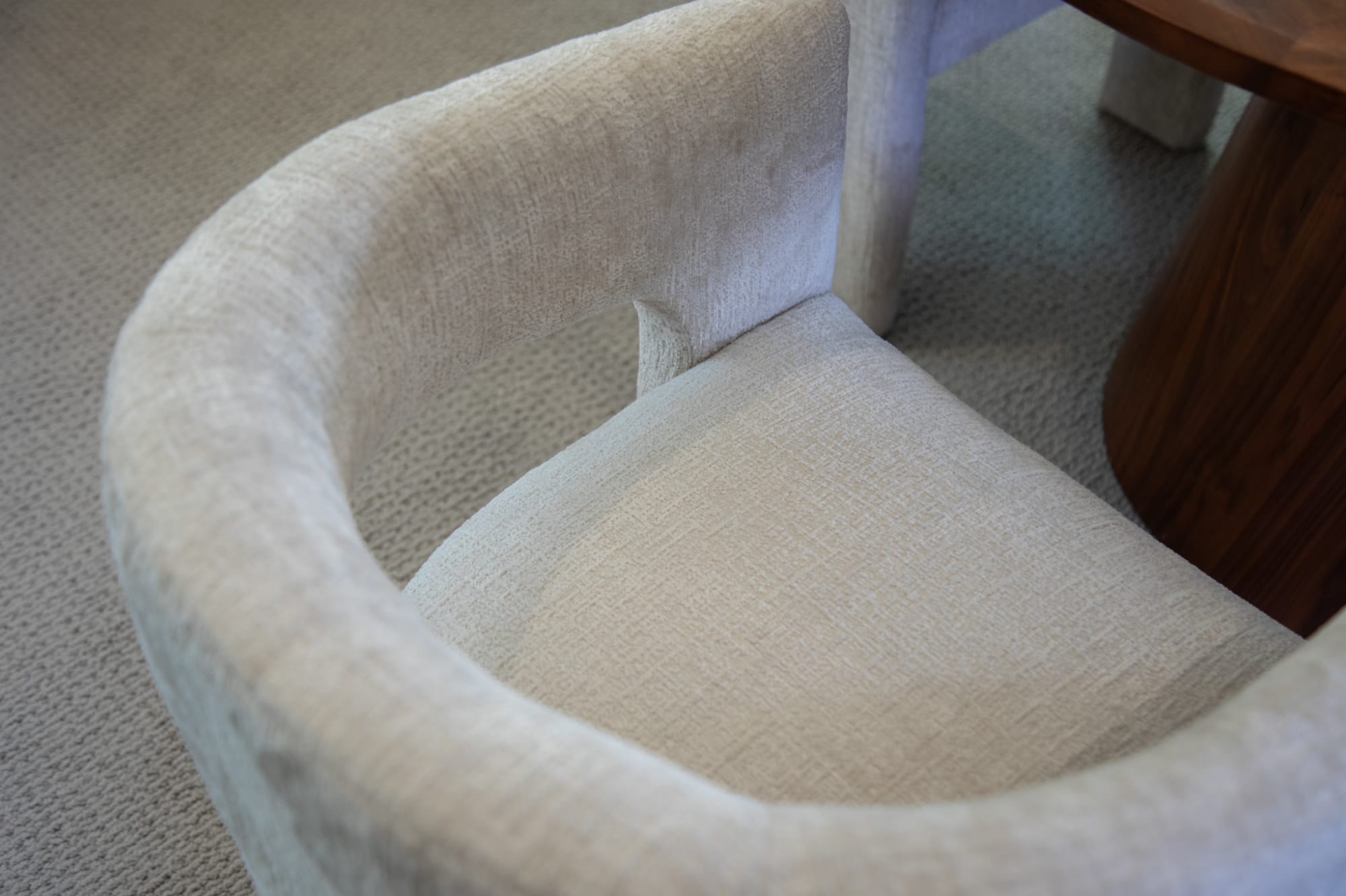 The white Nash Dining Chair at a table