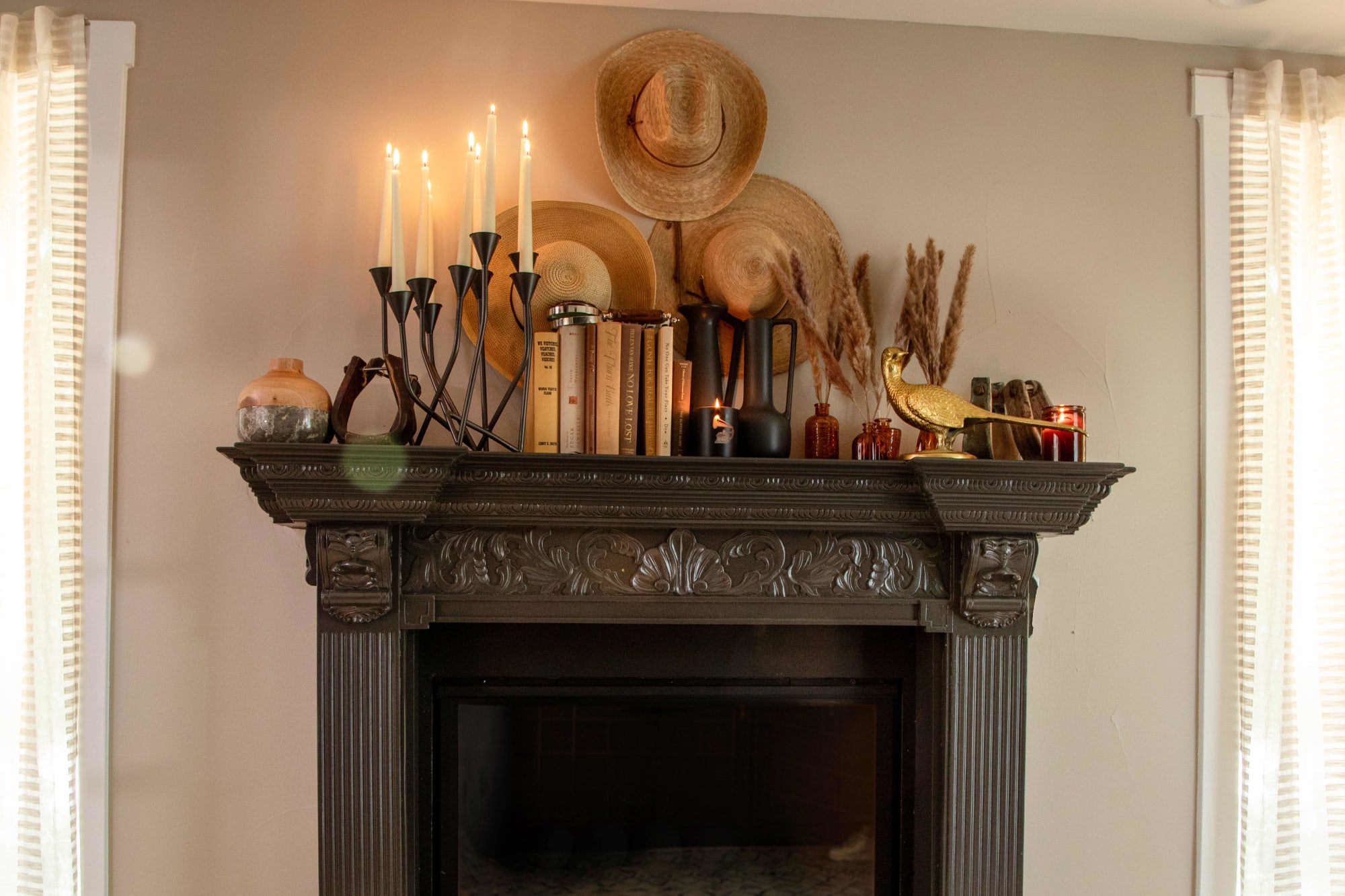 Black Ornate Fireplace Mantle Decorated For Fall