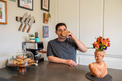 Furniture Row Employee drinking coffee at a counter height table