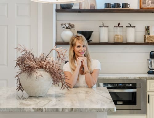 Closeup shot of Kelli Bateman sat at marble island in her home kitchen