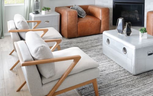Saddle Colored Leather Chair, Cream Fabric Chairs, Silver Coffee trunk and other modern decoratively styled products