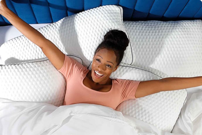 woman laying in bed with pillows