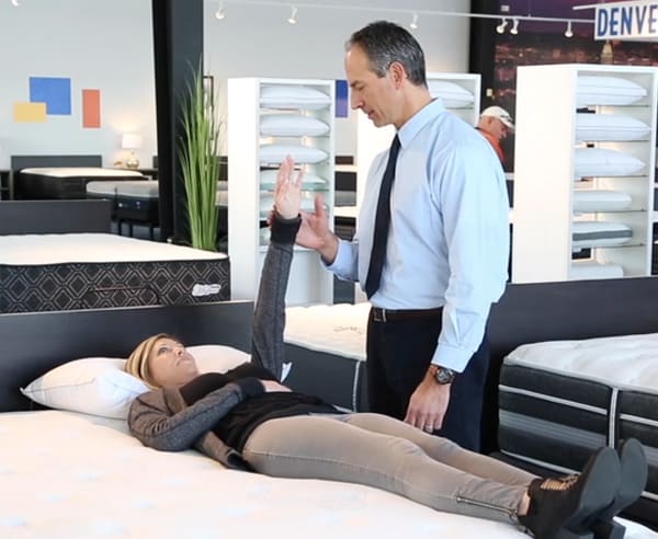 mattress expert conducting the Strength Reistance Test with a customer