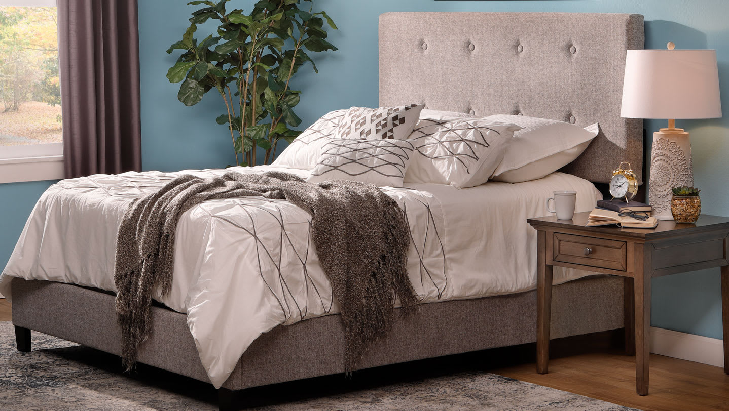 The gray Hermosa Upholstered Bed in bedroom window scene with blue walls