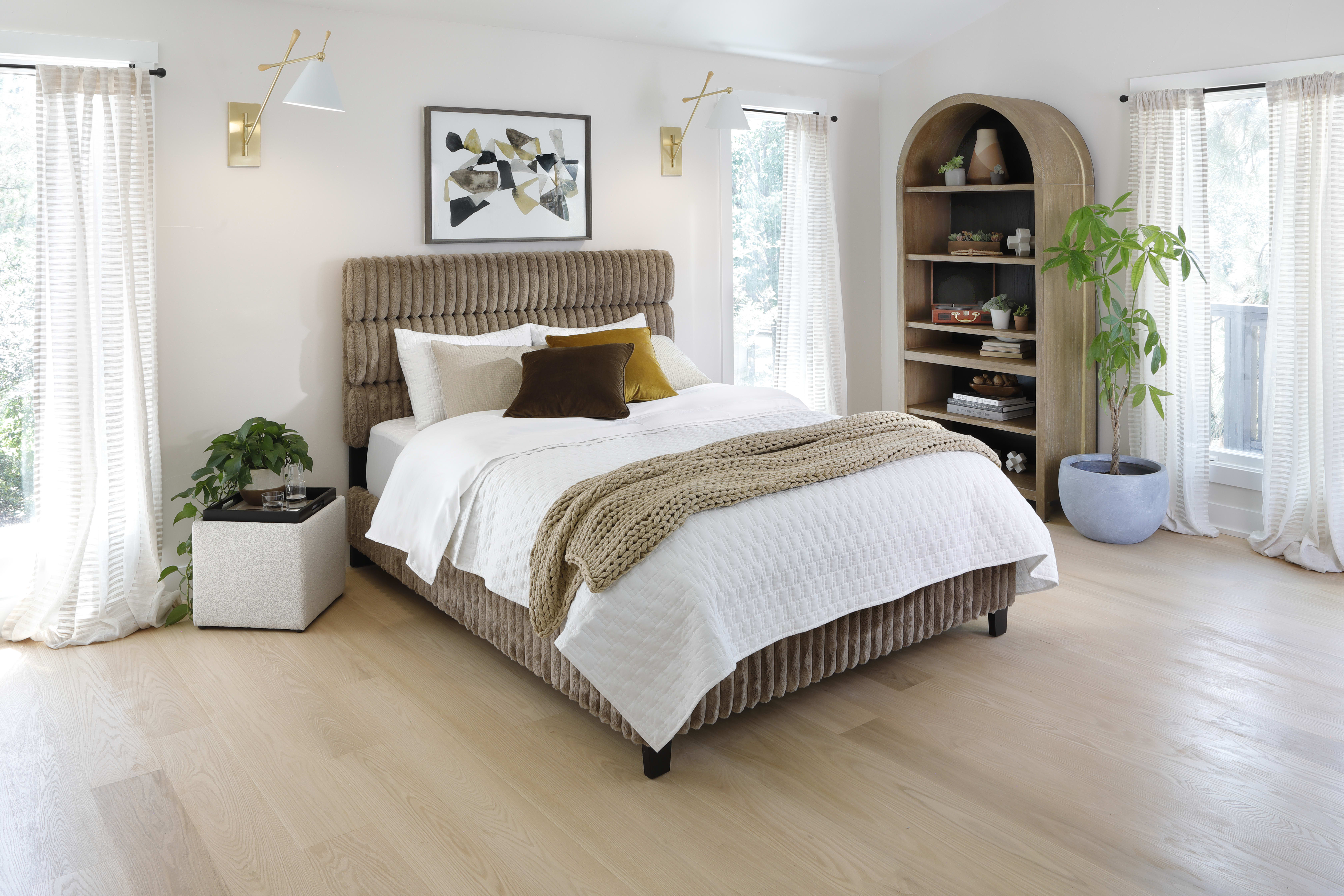 Light brown upholstered bed with oversized corduroy texture in sunny bedroom