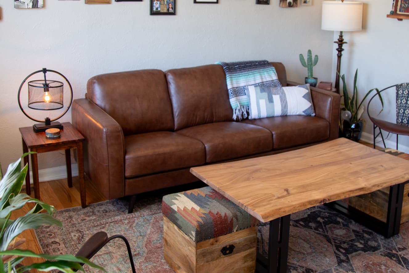 A brown leather sofa, the Tivoli Sofa, with industrial coffee table in a living room