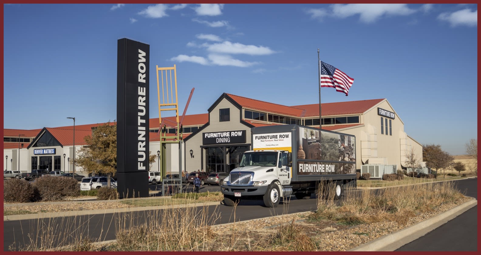 delivery truck driving past Furniture Row store