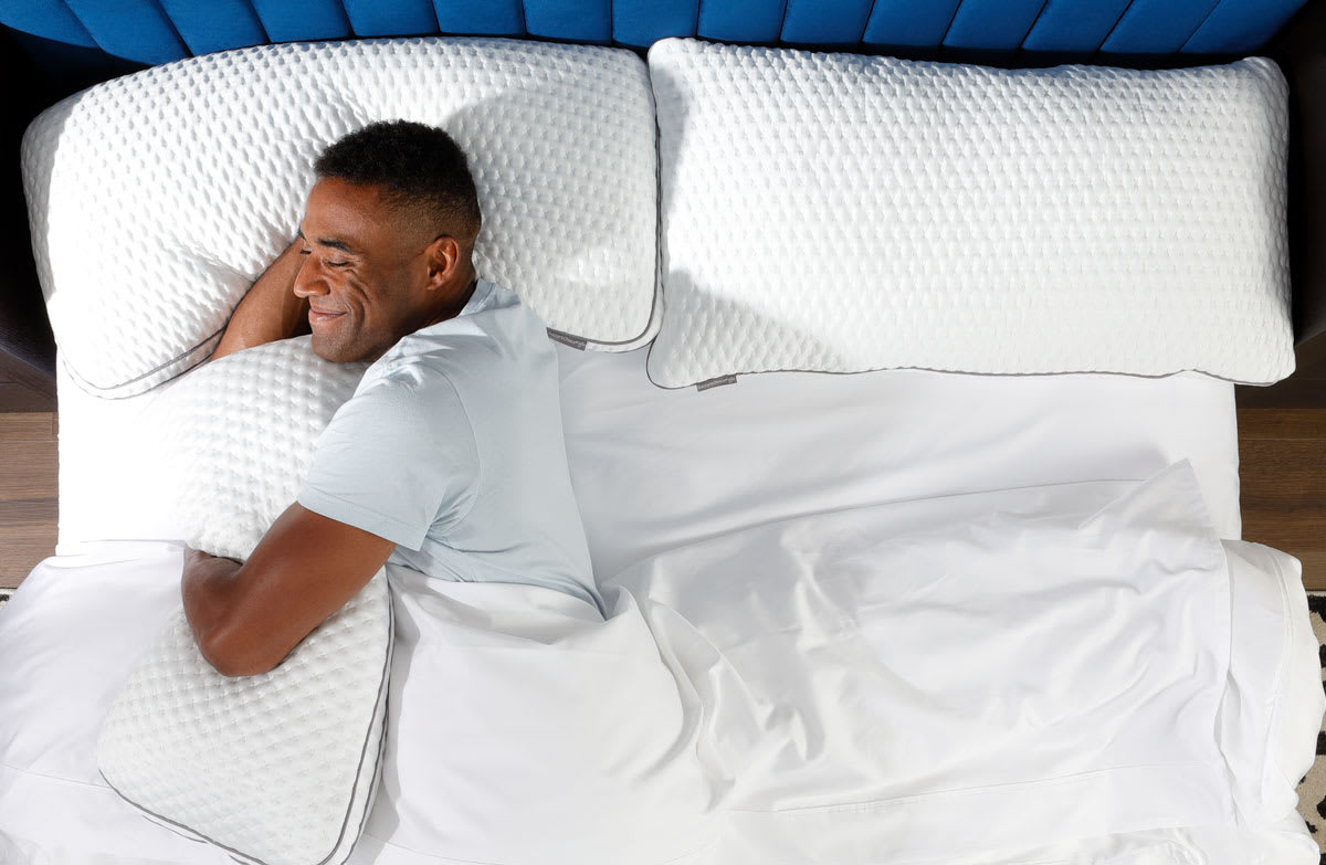 Man Sleeping in Bed Snuggling Doctors Choice Elite Pillows