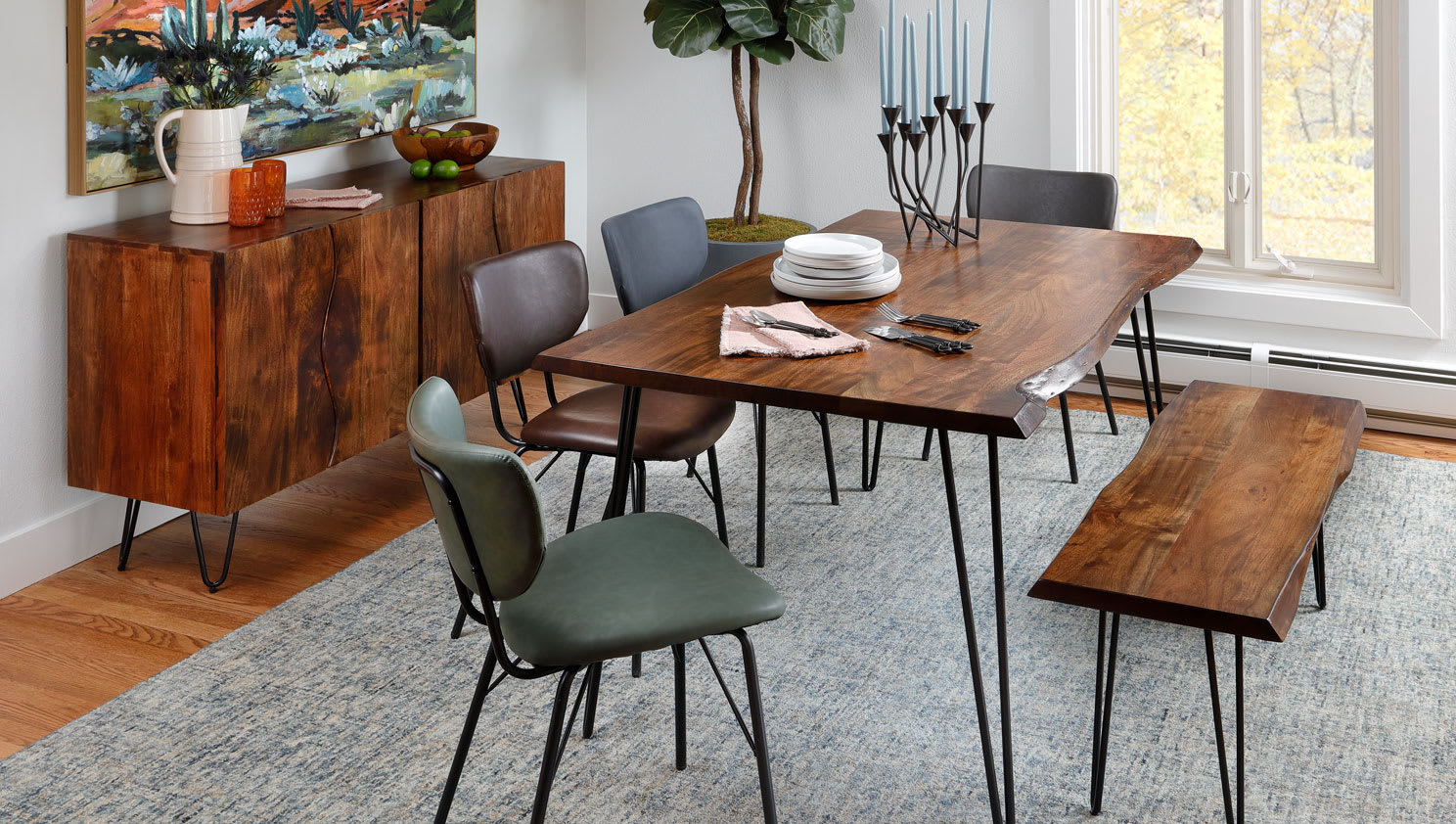 Live Edge Dining Set with hairpin legs and leather chairs in dining room with Fall trees visible through window