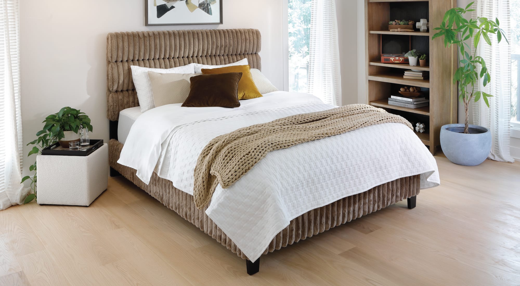 Light brown upholstered bed with oversized corduroy texture in sunny bedroom
