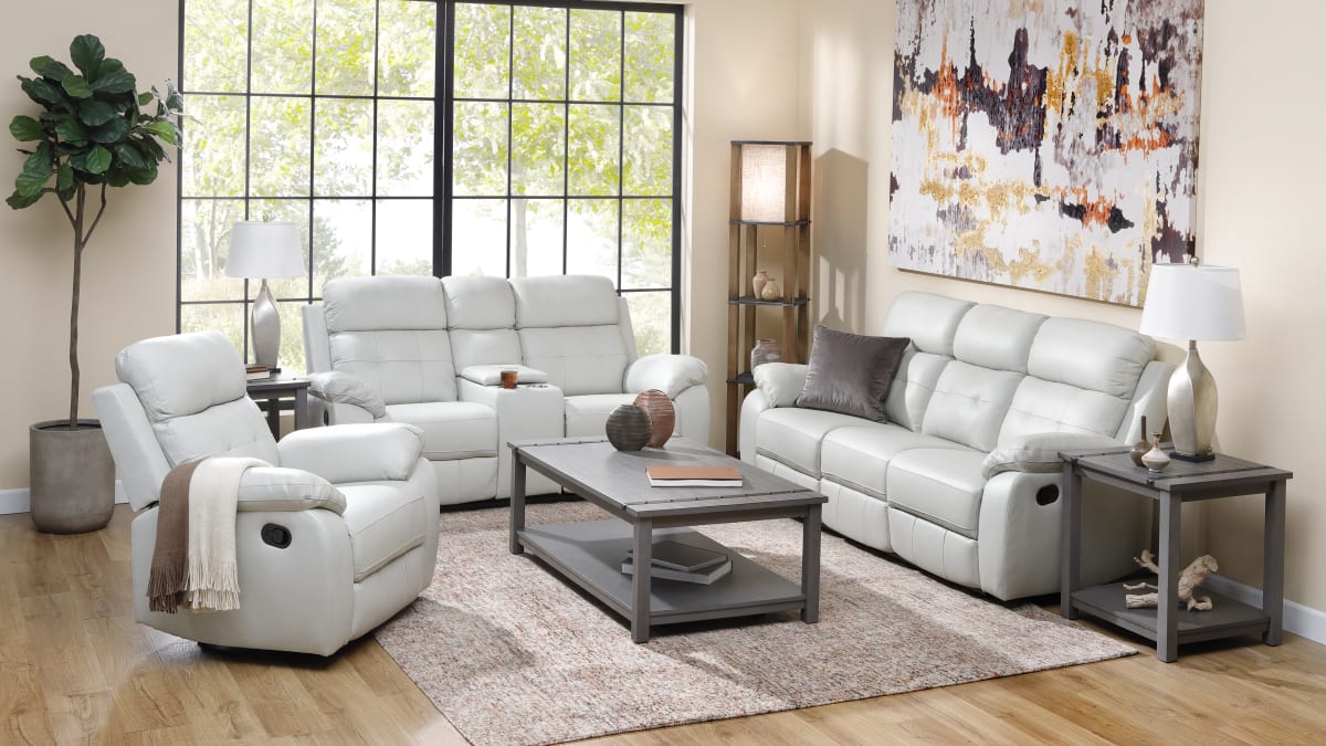 Very light grey leather reclining sofa set in a living room with a rectangular coffee table