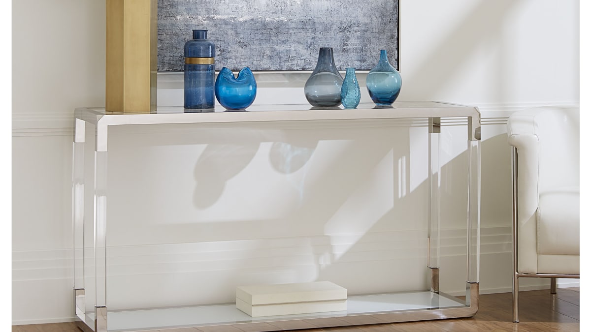 A glass entryway table, the Joelton Sofa Table, in a modern room