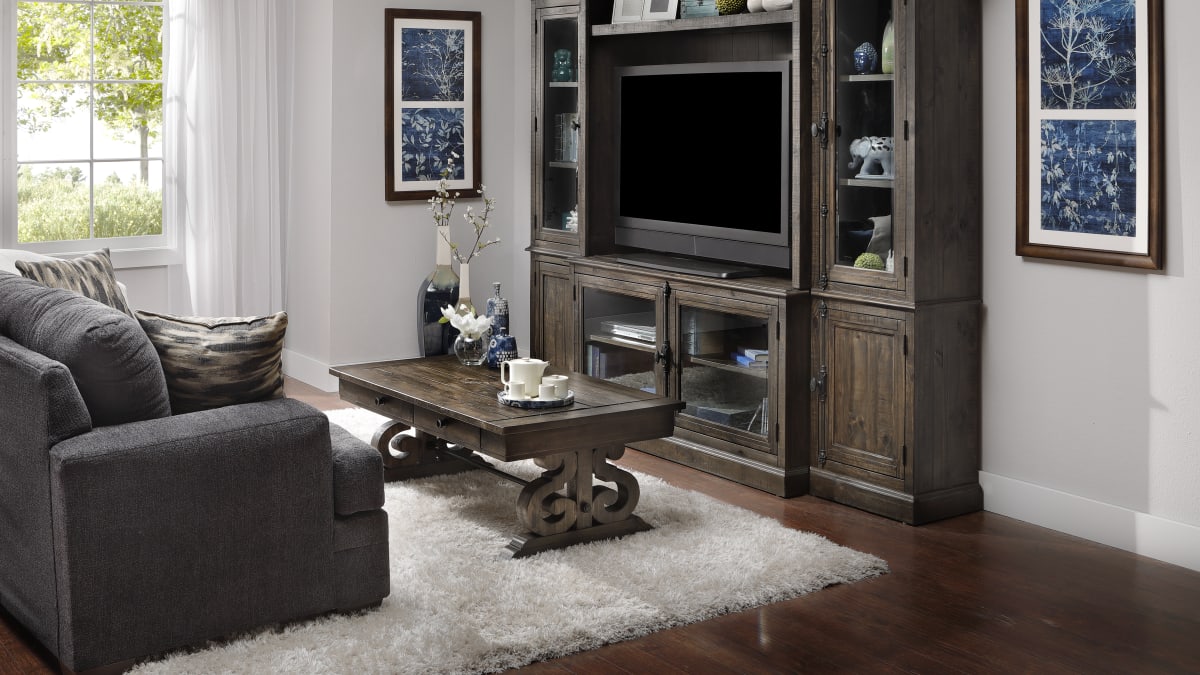 A wooden coffee table and wooden entertainment center with farmhouse charm in a living room