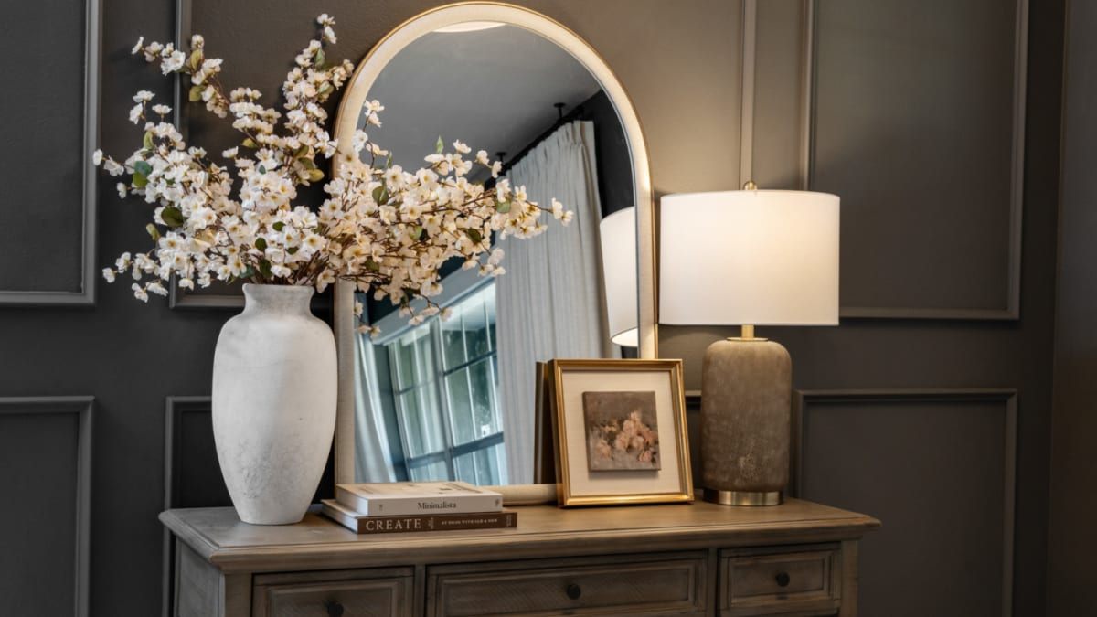 Entryway table with mirror and neutral decor in Kelli Bateman's Airbnb front entry