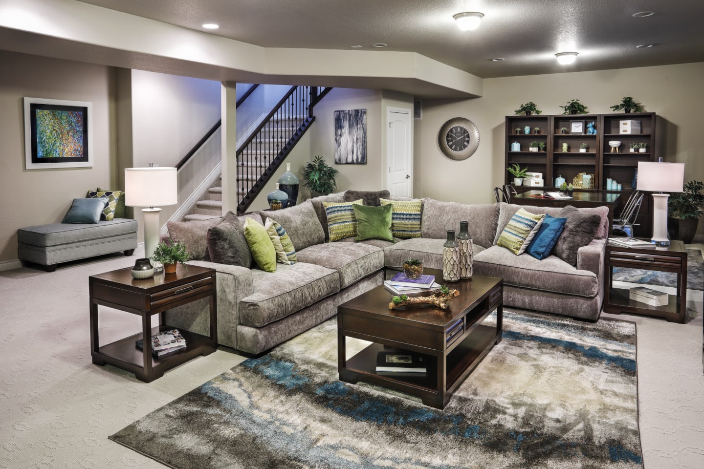 A roomy sectional in an entertainment room with bright throw pillows