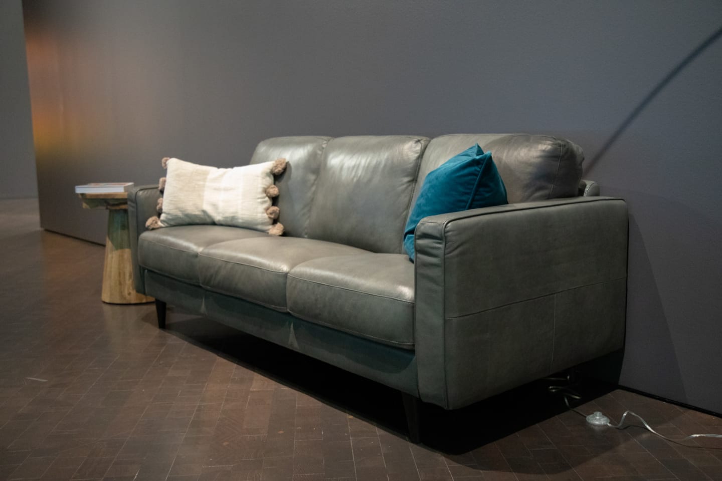 Gray leather sofa with track arms featured at the Denver Art Museum
