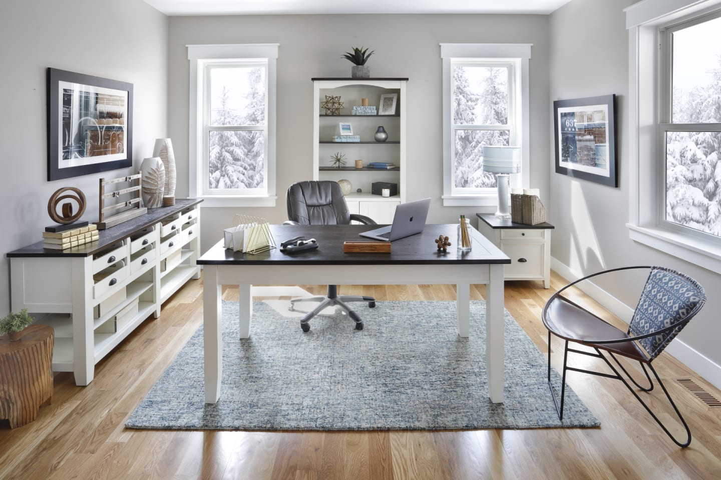 A white writing desk with a dark wood top, the Mountain Home Desk, with other matching pieces in a home office