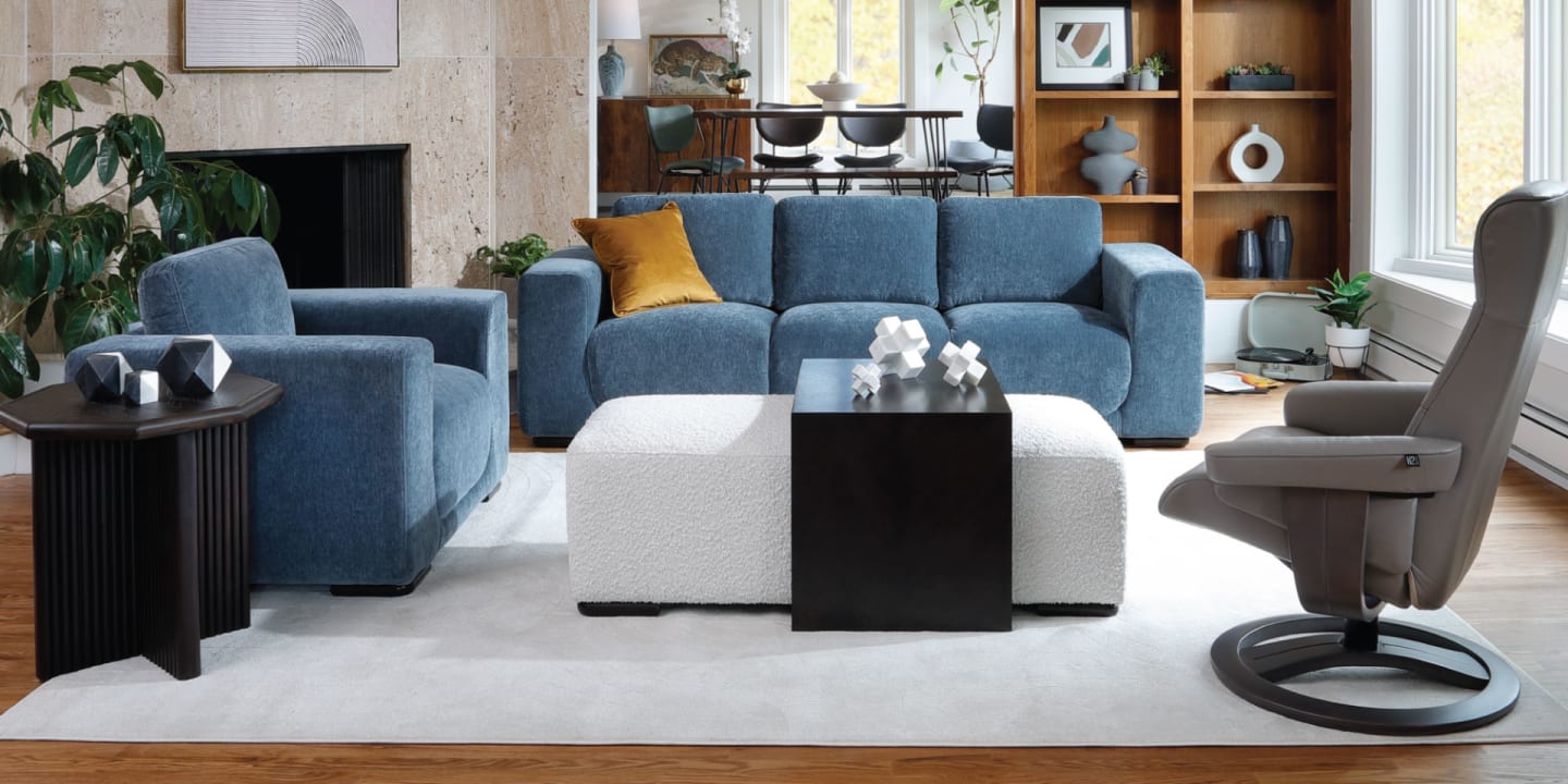 Wide shot of Jasper Sofa with a matching chair, coffee table ottoman, and accent chair