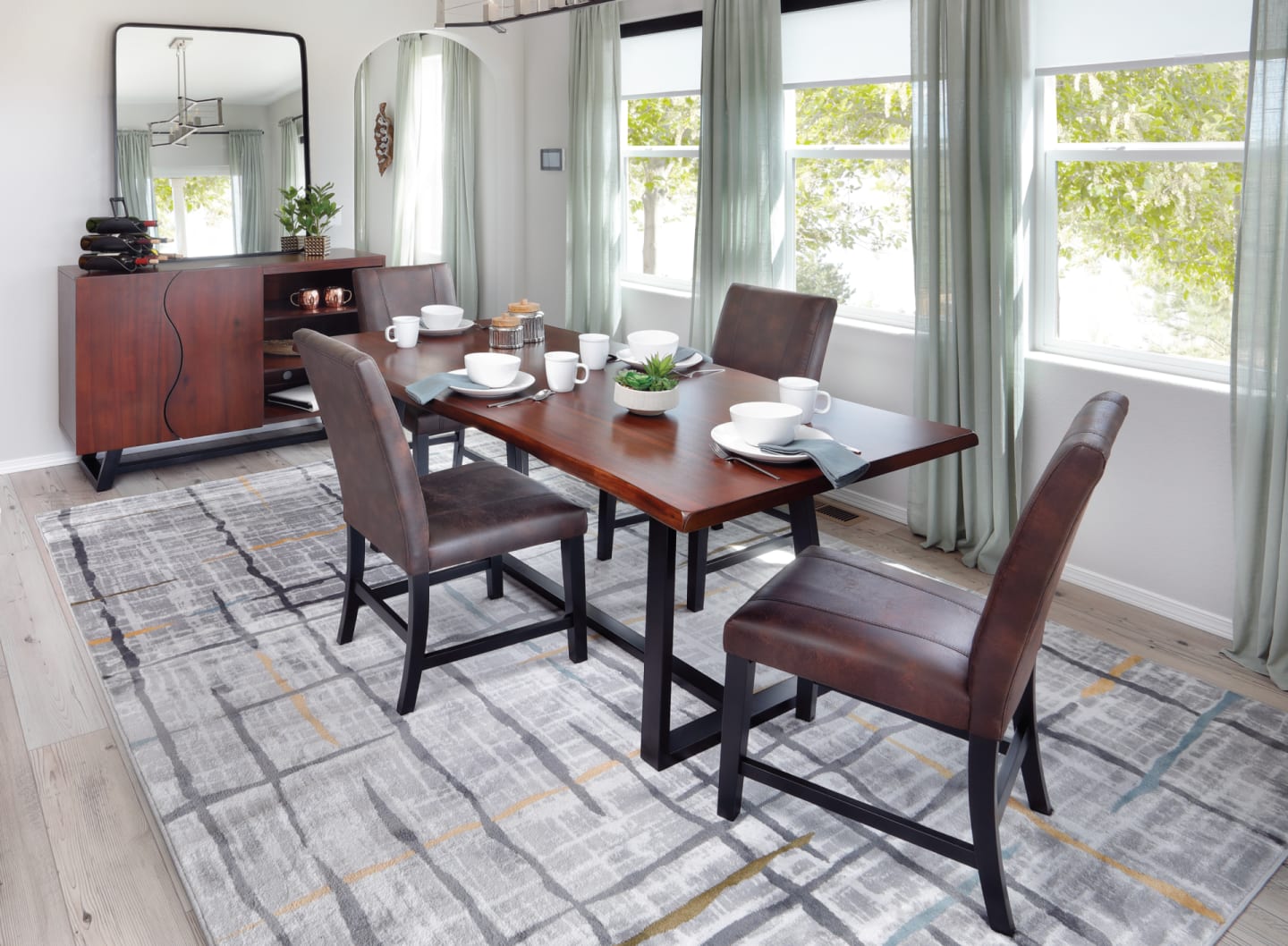 A contemporary-industrial dining set featuring a live edge dining table with metal base and four upholstered dining chairs
