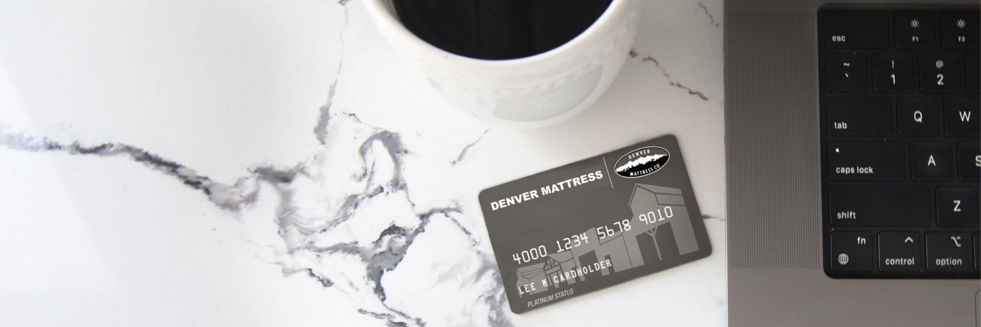 Furniture Row Credit Card next to computer with cup of coffee