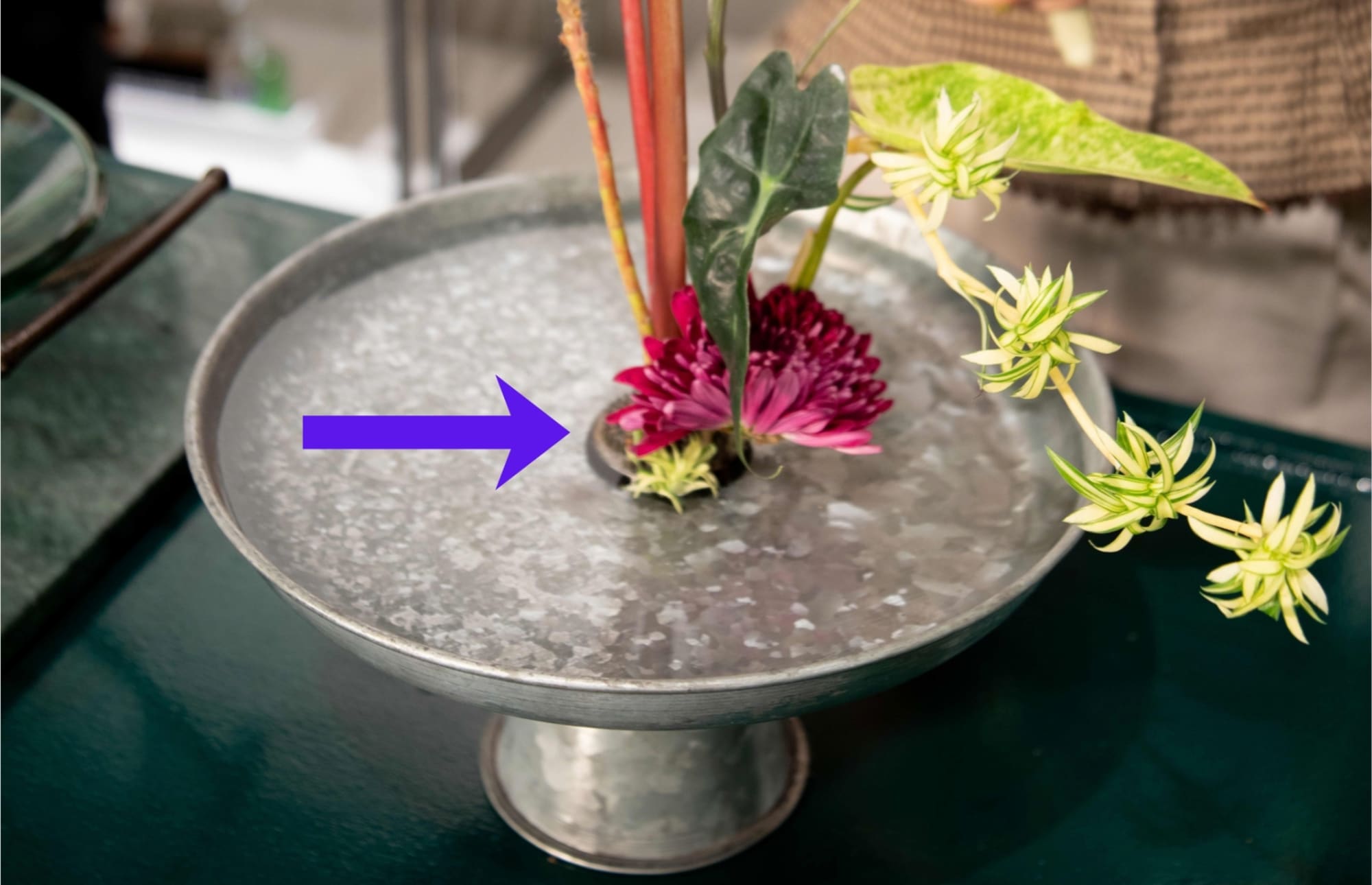 An ikebana with a pin frog at the base