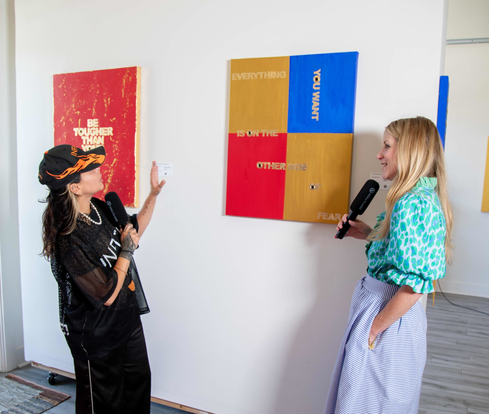 Fresh Sam showing Seated podcast co-host Barb pieces from her debut art exhibit