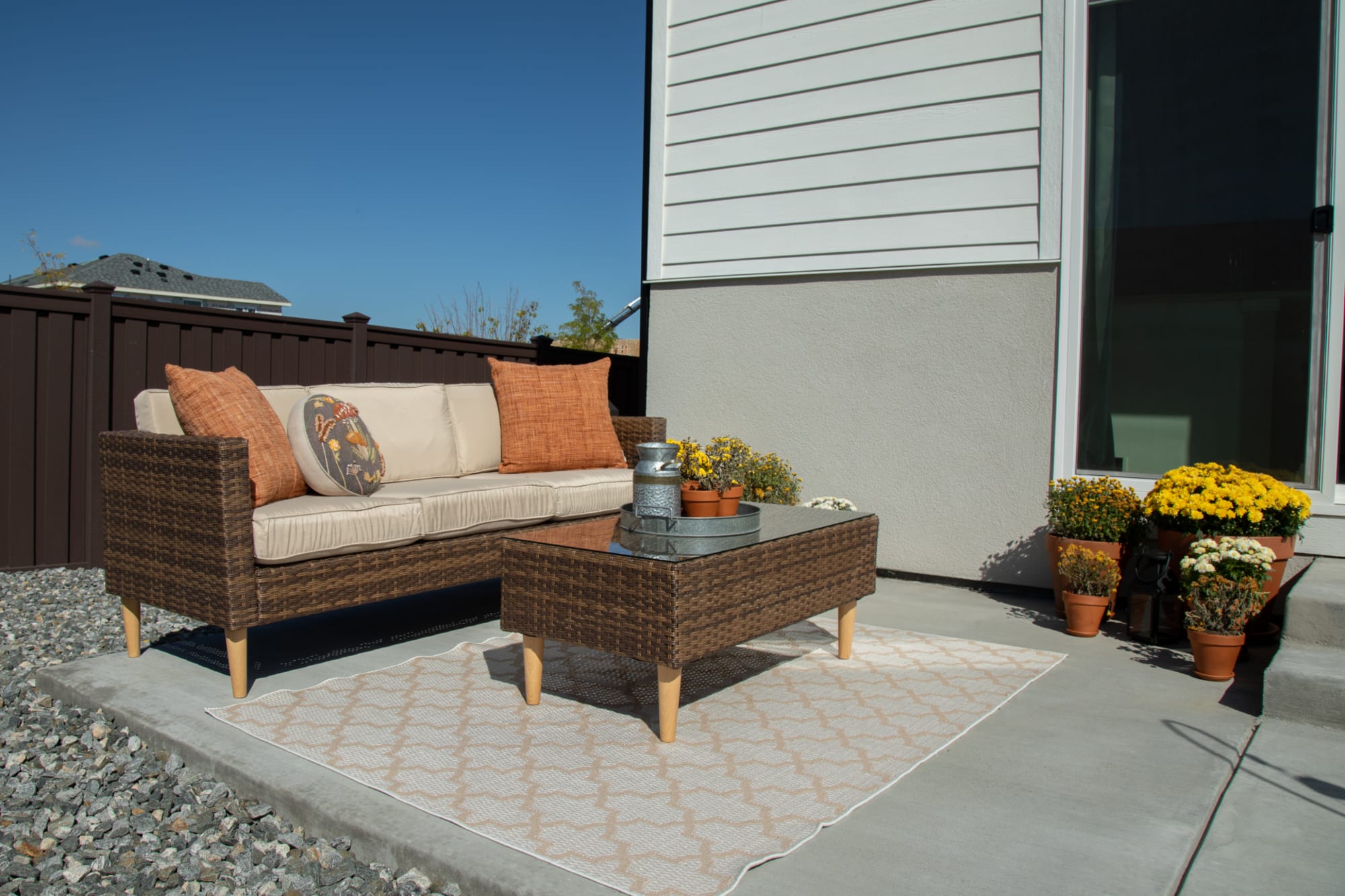 The San Bruno Patio Set, fetauring a Patio Sofa and Coffee Table, staged outdoors at St Jude home
