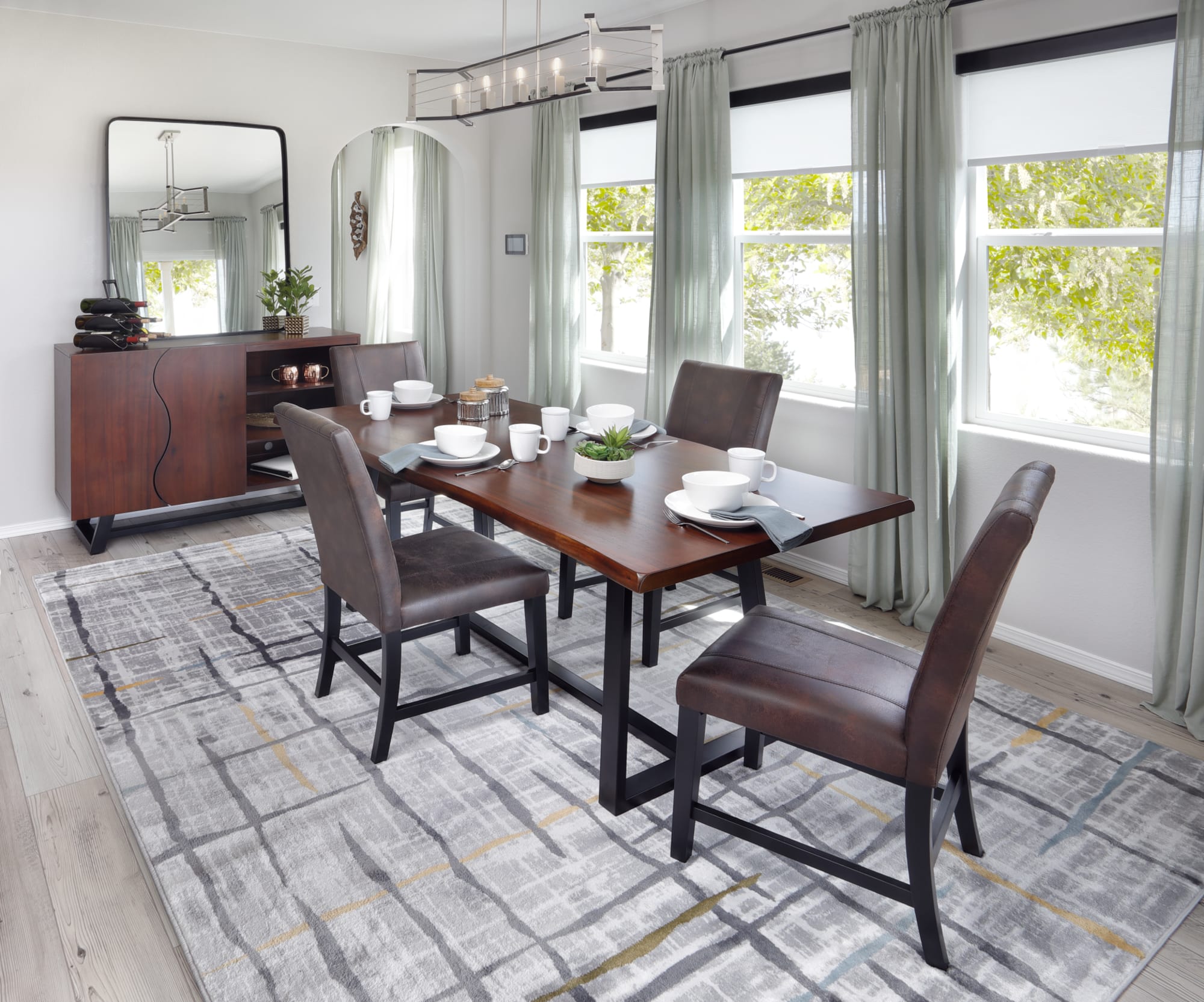 A contemporary-industrial dining set featuring a live edge dining table with metal base and four upholstered dining chairs