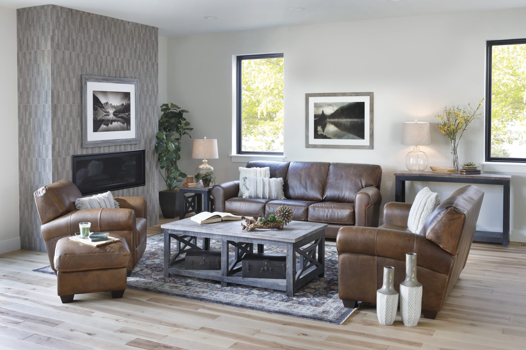 Brown leather sofa, loveseat, and chair accompanied by wood coffee table and rug