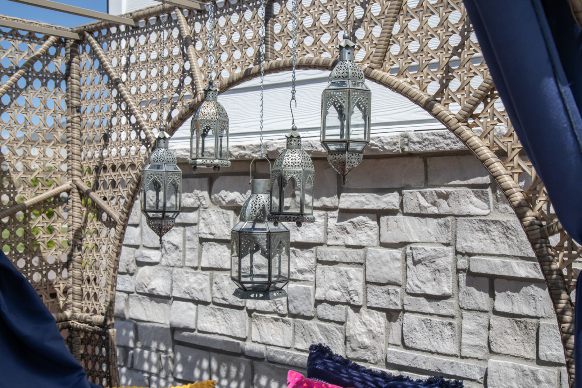 Zoomed in shot of Moonstone Cove Wicker Daybed with silver finished hanging lanterns