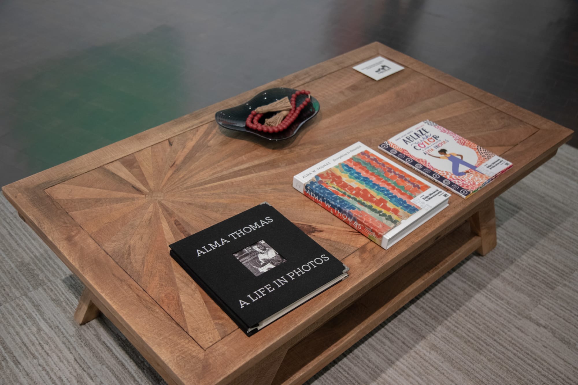 Rustic wood coffee table with sunburst inlay displayed at Denver Art Museum