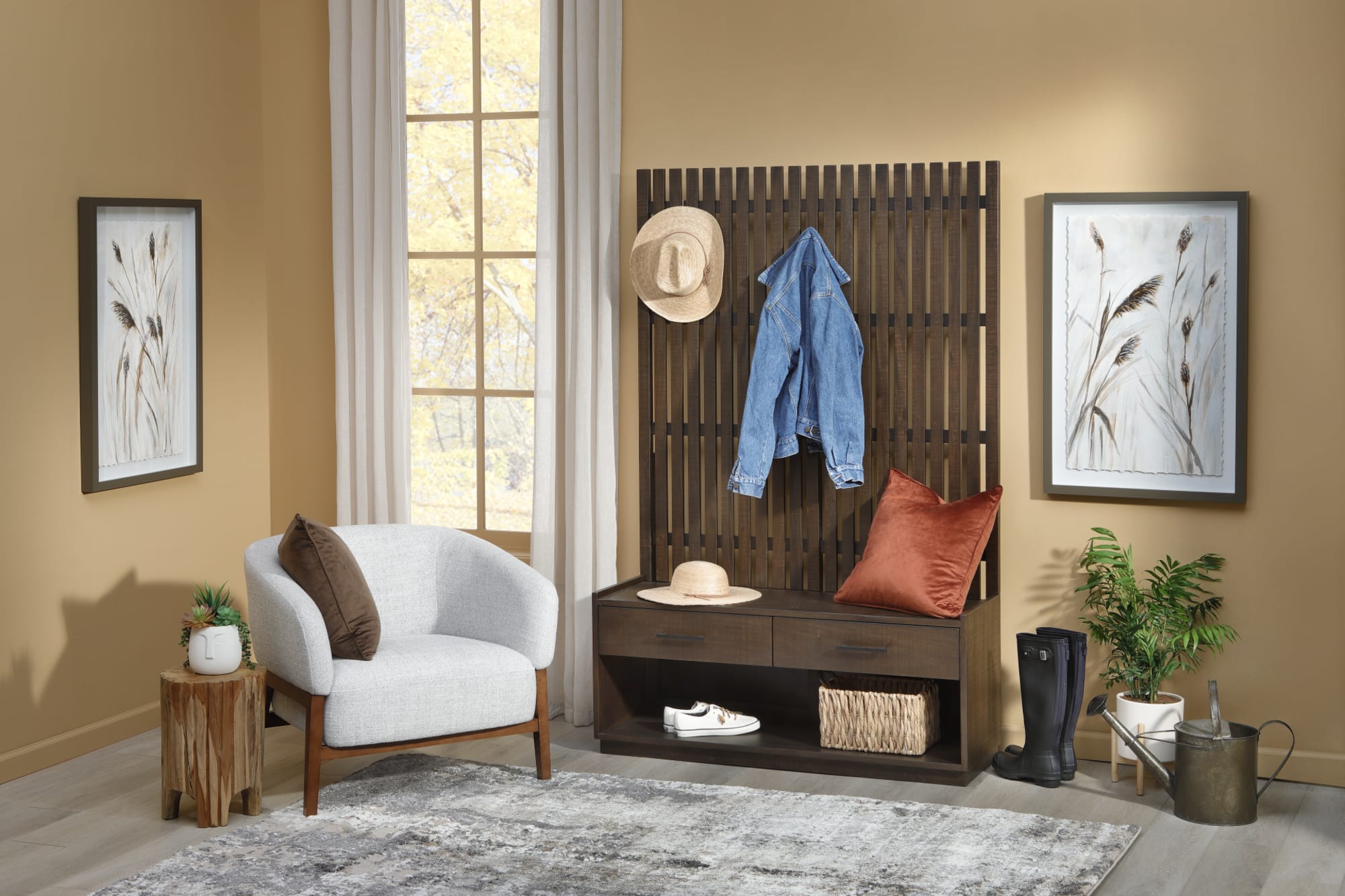 A wood hall tree organizer in an entryway with a white accent chair