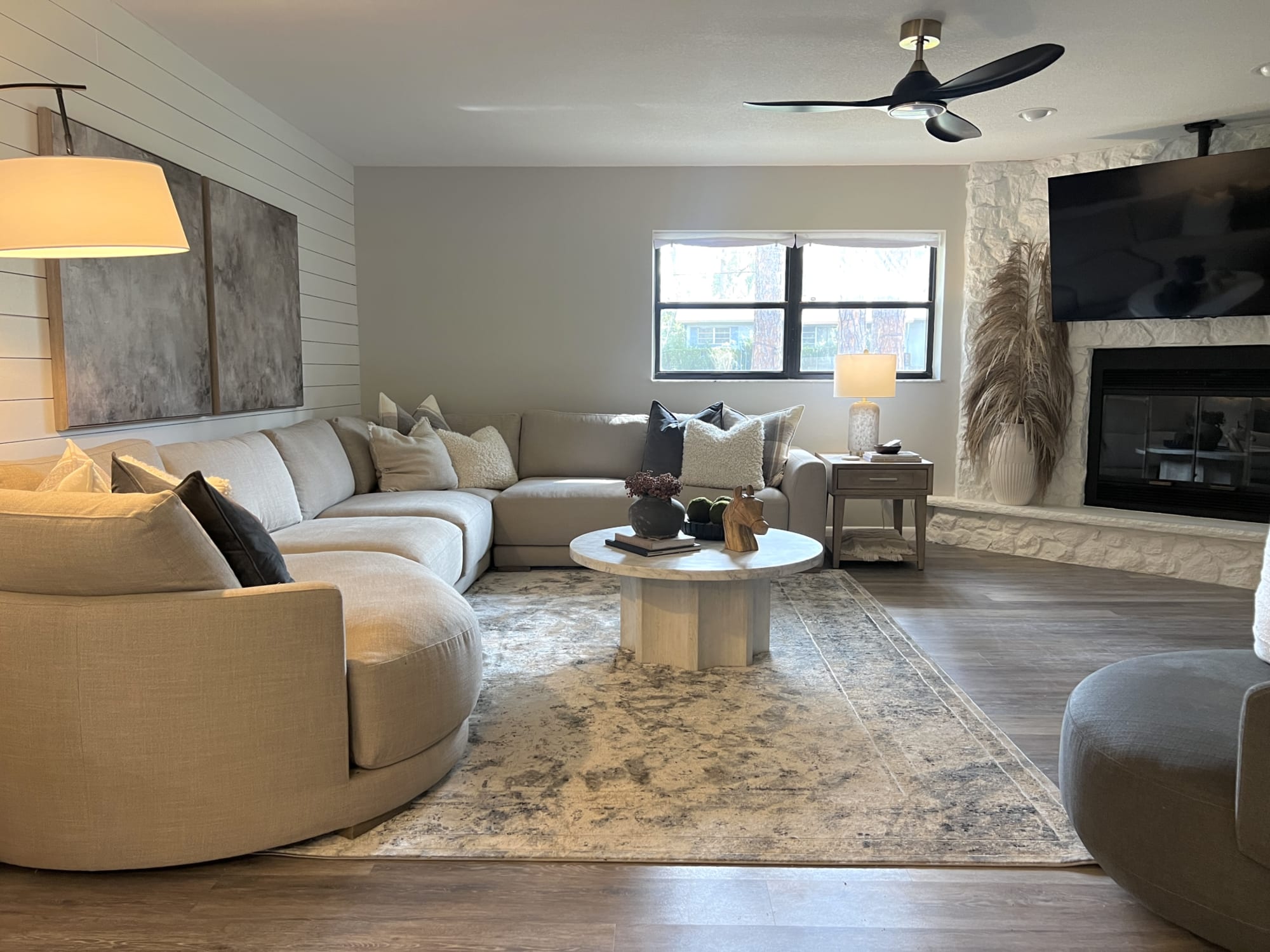 Beige modern sectional and marble coffee table located in Kelli Bateman's Airbnb family room