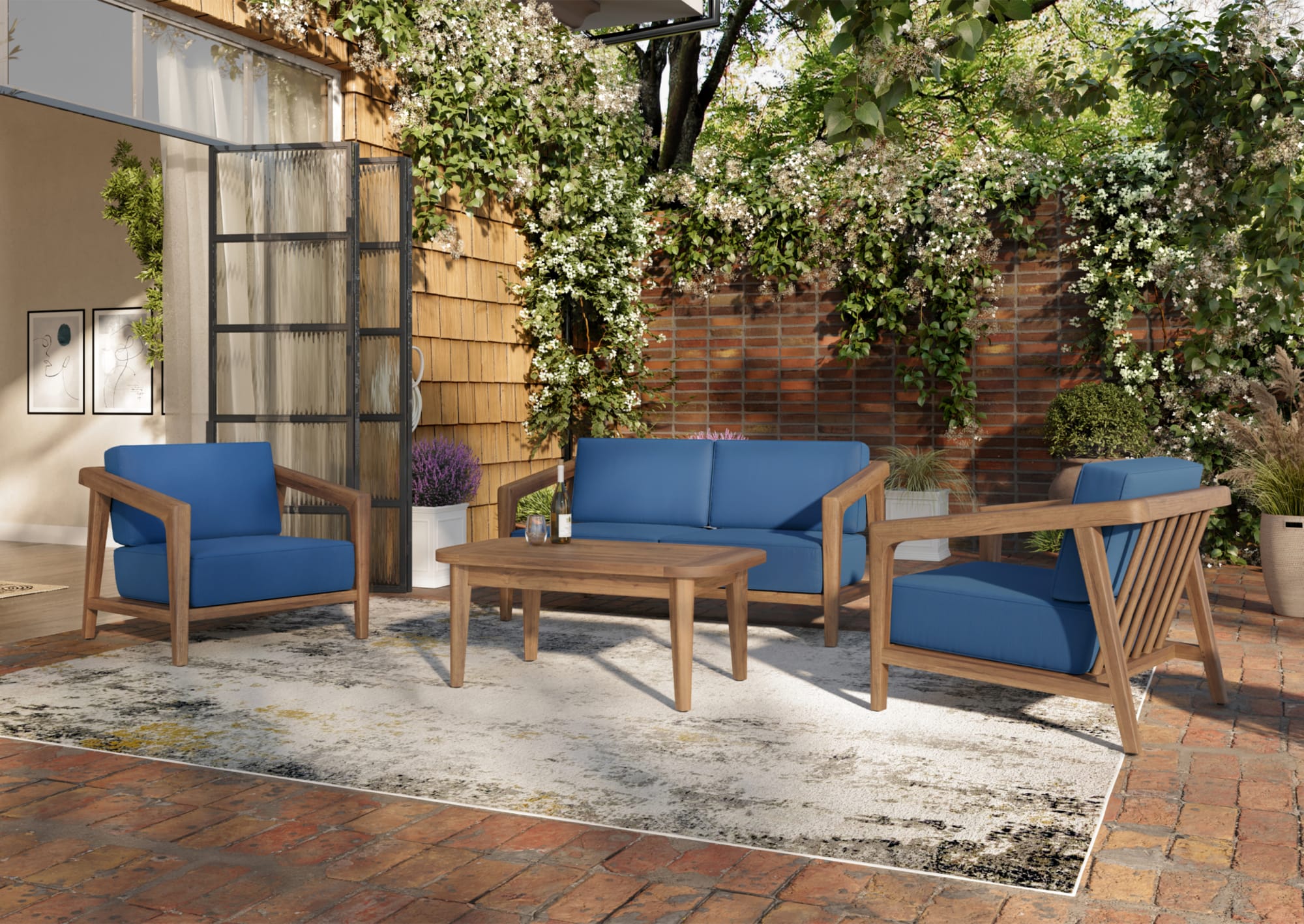 A low-profile patio sofa group with blue cushions on an outdoor patio