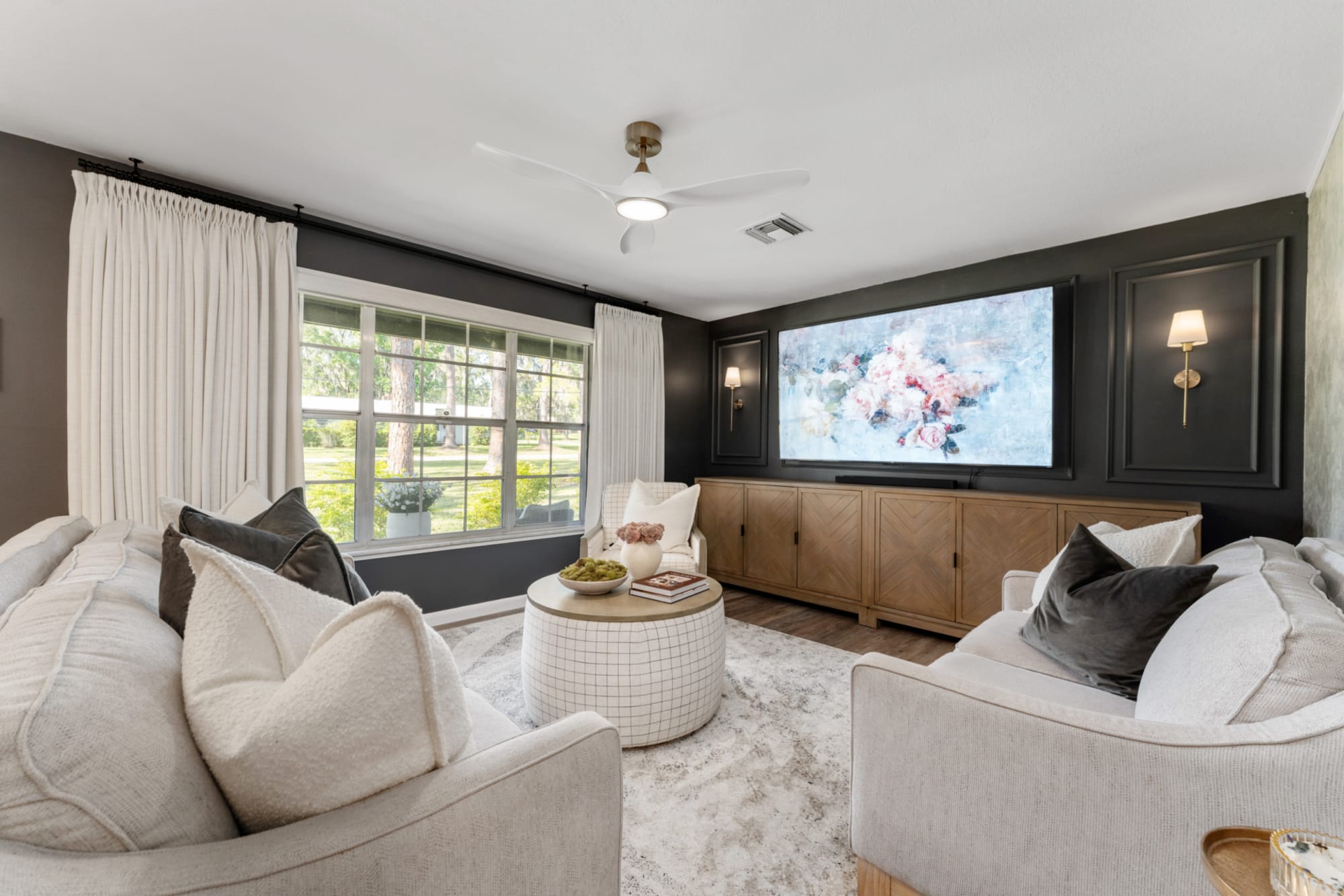 Round coffee table styled in center of Kelli Batemen's Airbnb living room