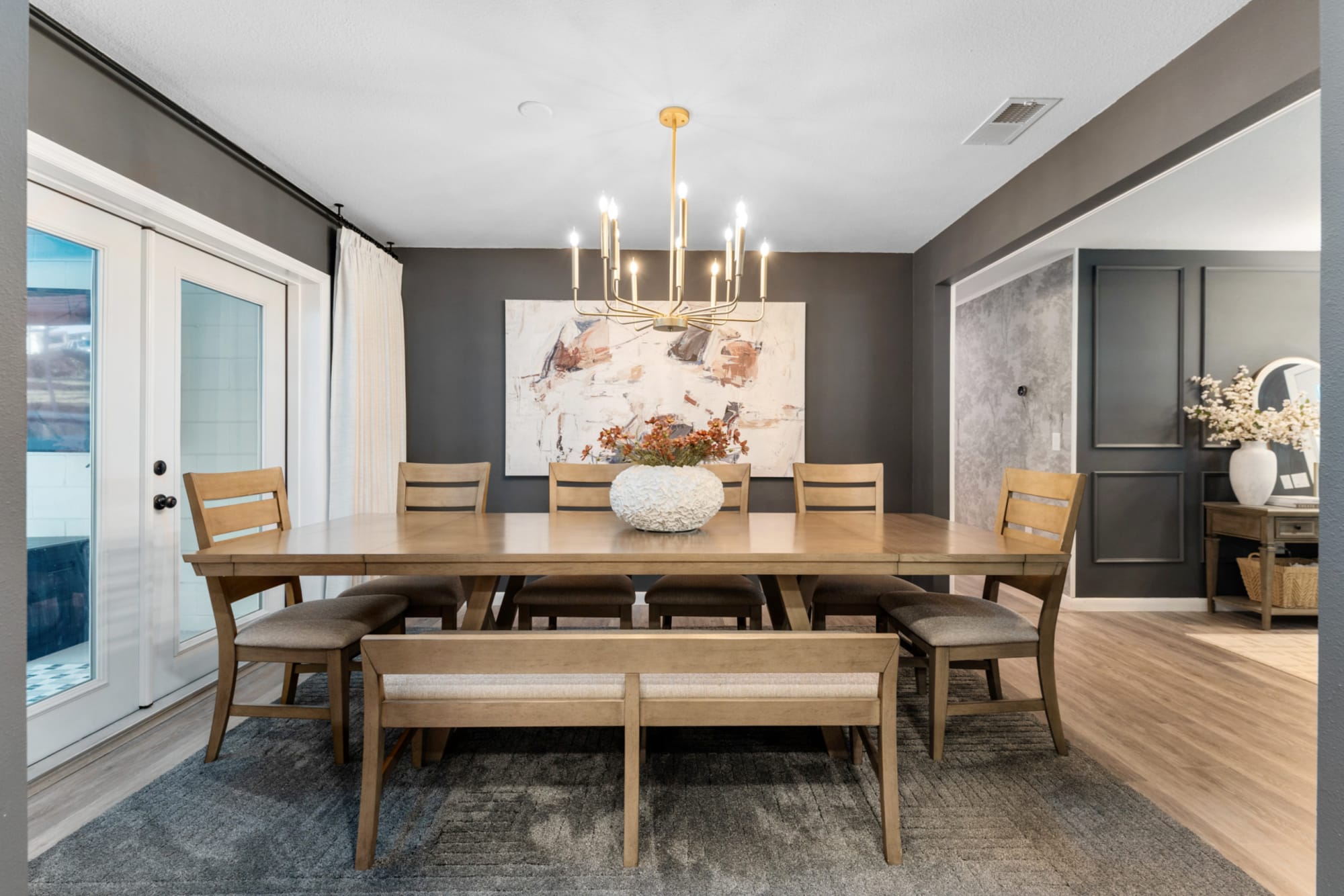Modern light wood dining set with bench in Kelli Bateman's Airbnb dining room