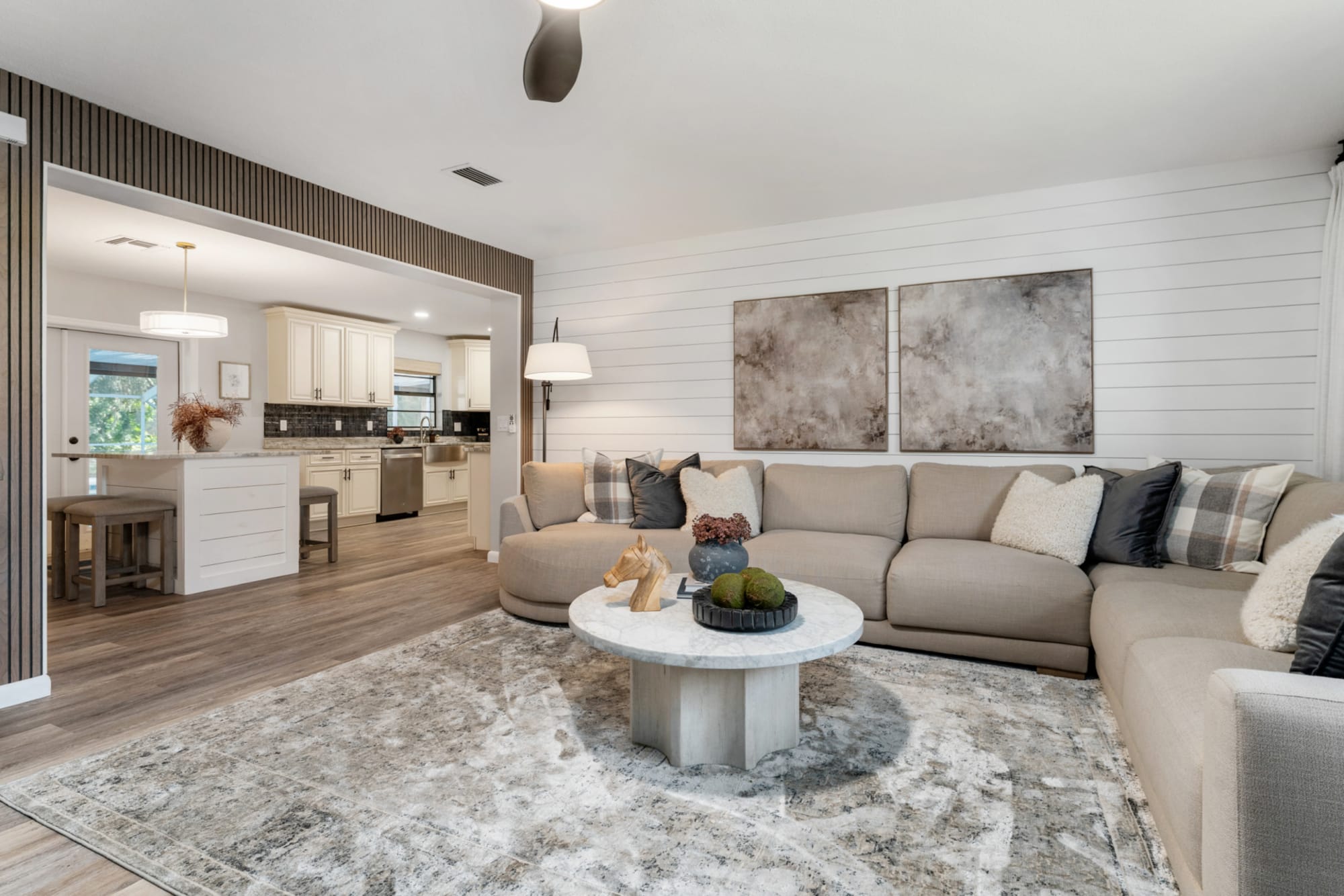 Large beige sectional in Kelli Bateman's living room with marble coffee table