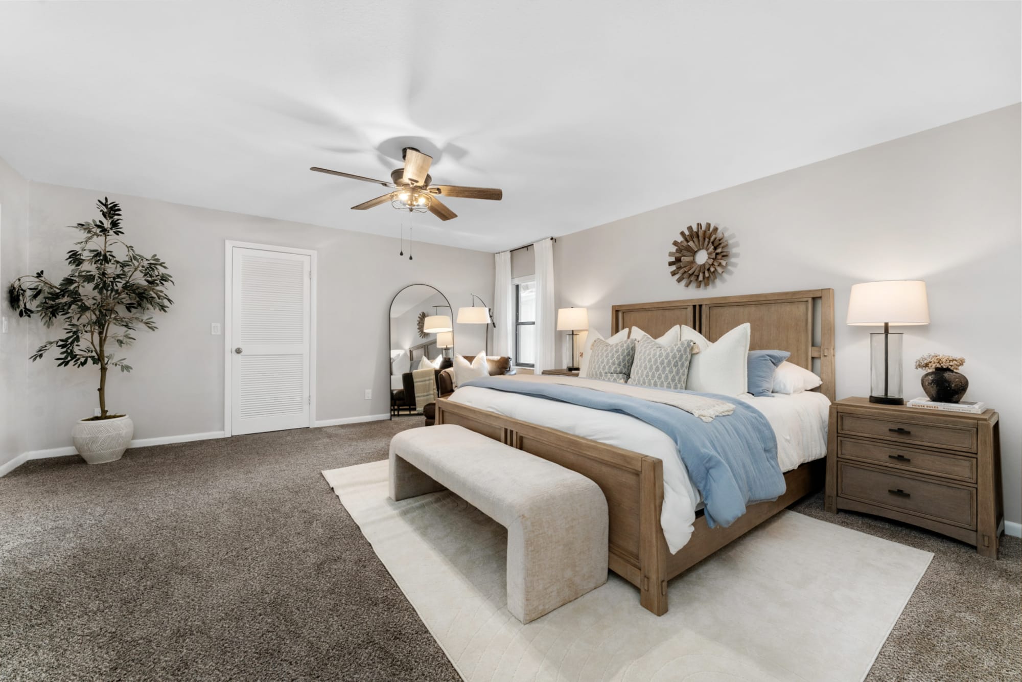 Large wooden panel bed with headboard in Kelli Batemen's Airbnb chic adult bedroom
