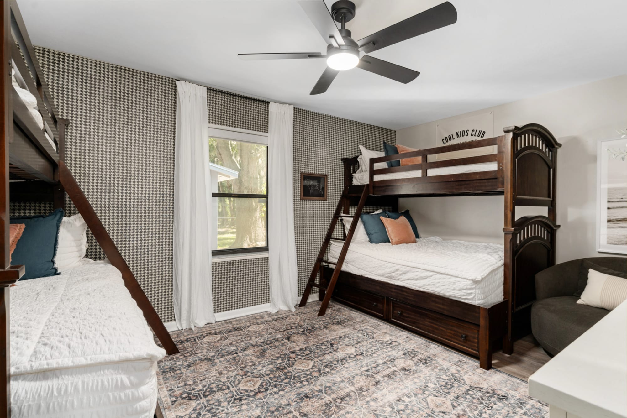 A twin over full bunk bed made from wood in a dark finish in a bunk bed room