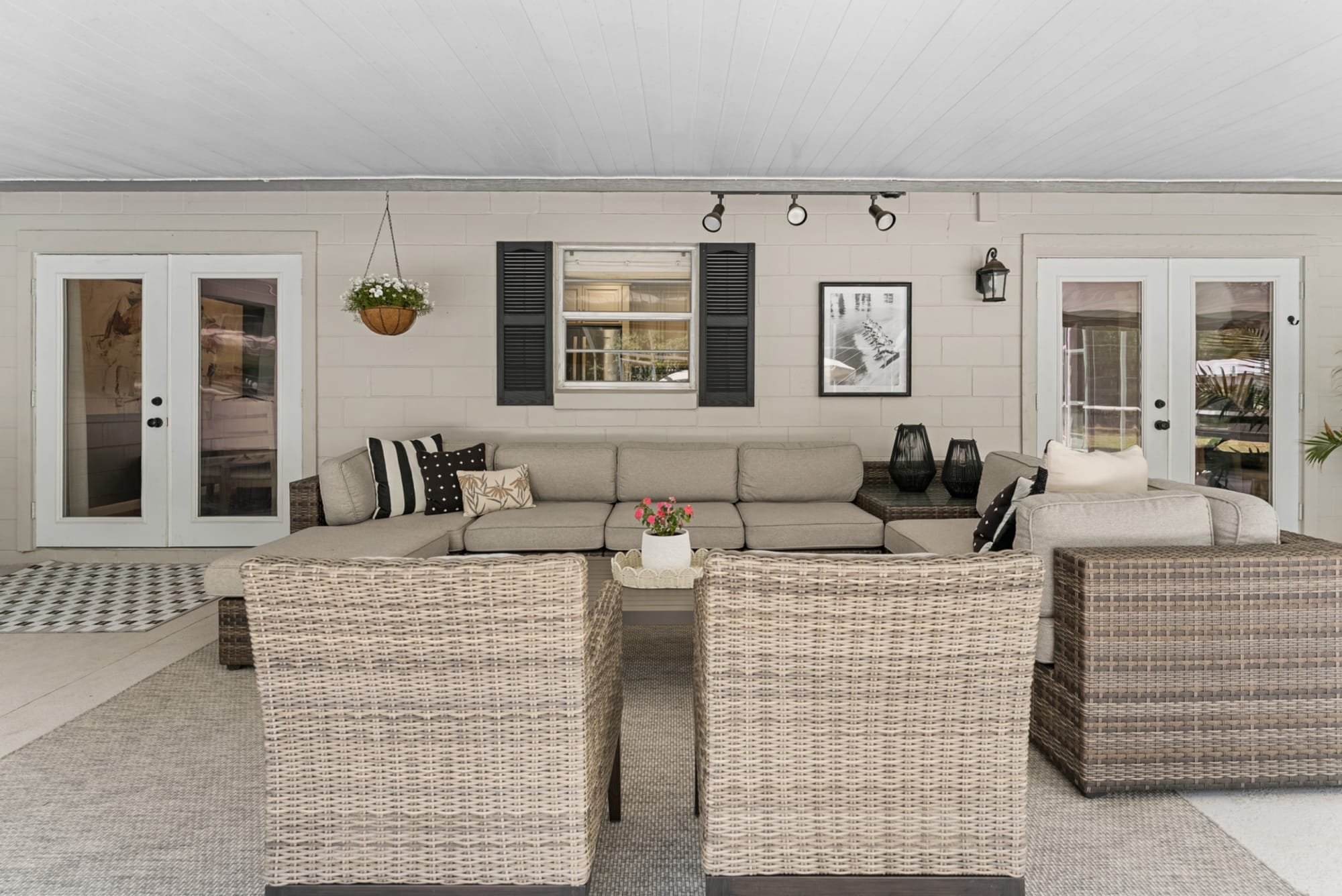Wicker eight-piece sectional with chairs and coffee table in Kelli Bateman's Airbnb patio space