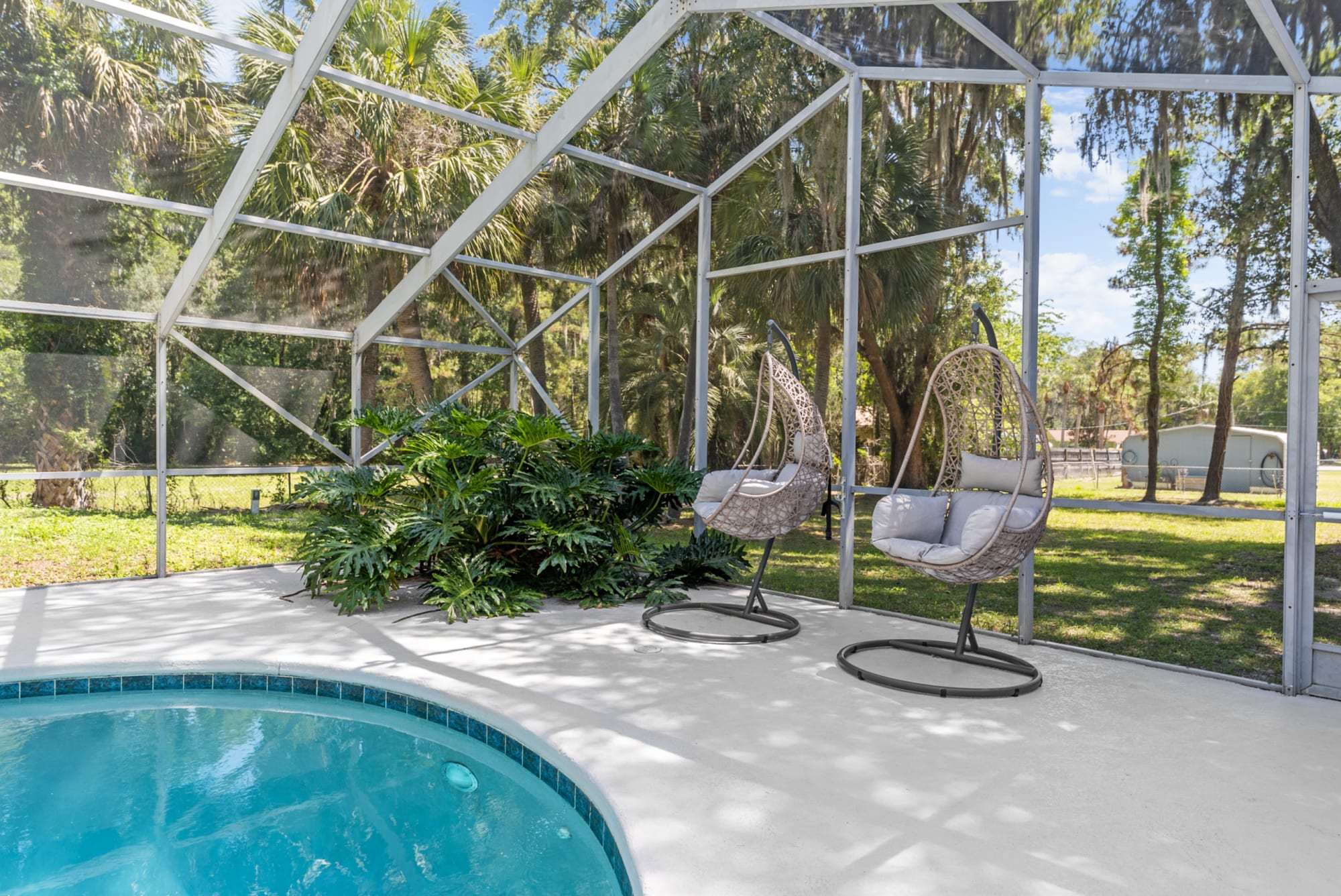 Two hanging basket chairs in Kelli Bateman's Airbnb patio