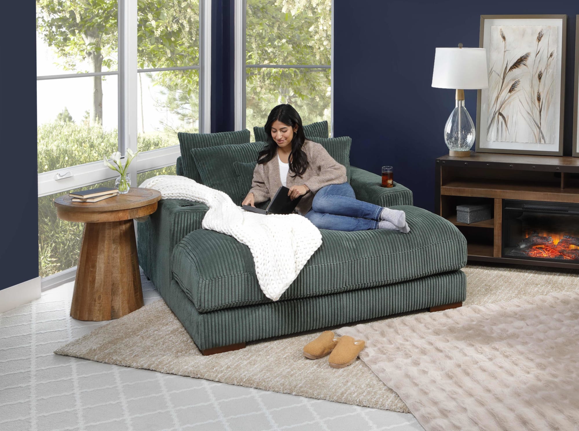 Woman reading on the Mondo Fabric Oversized Corduroy oversized chaise in Living room with woman reading