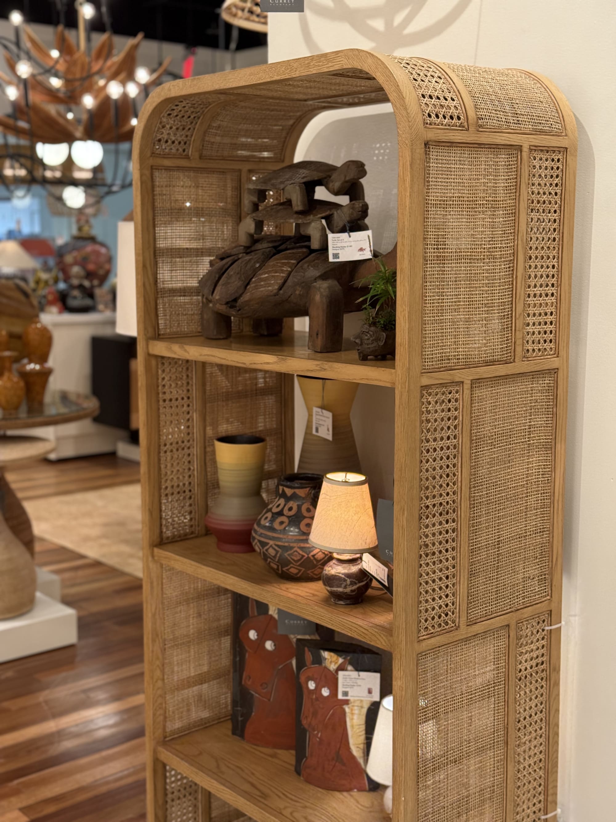 A curved bookcase with caning at High Point Marketplace