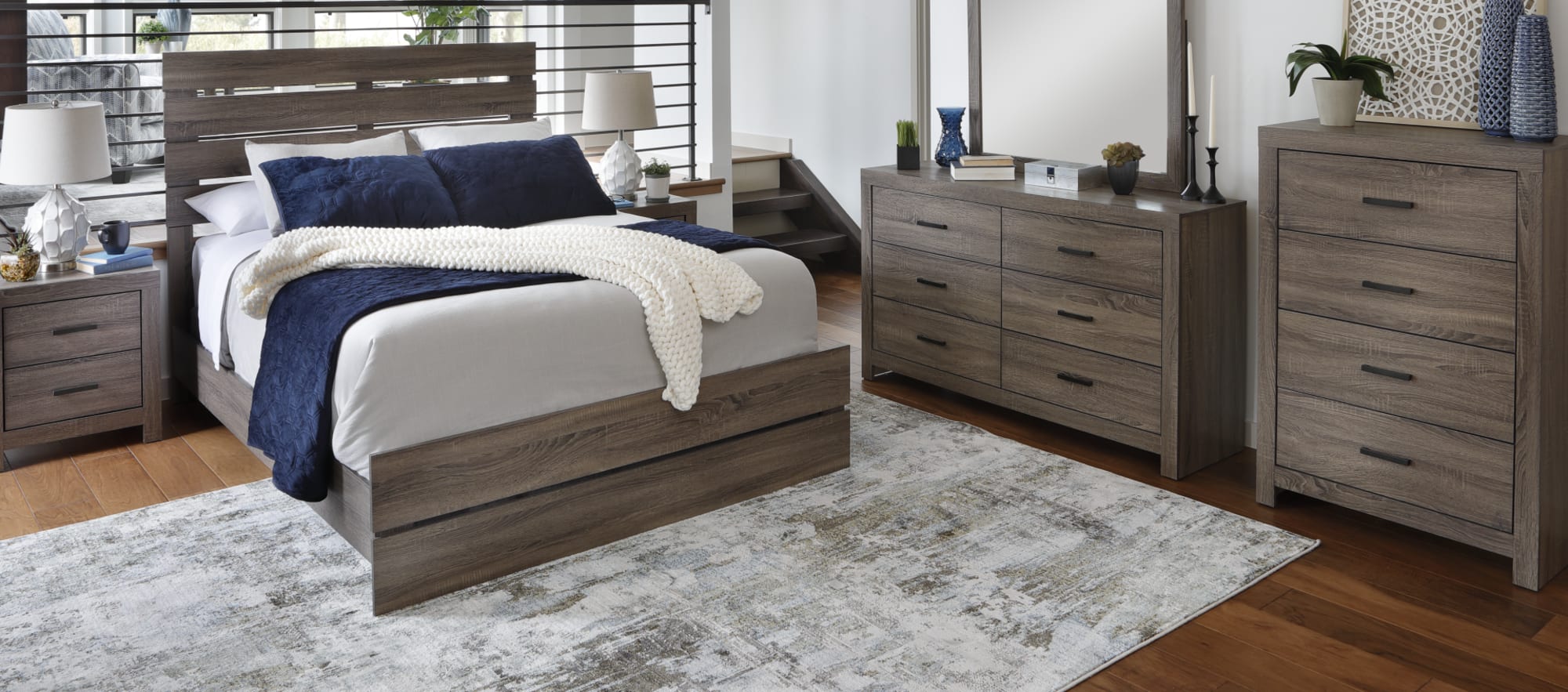 Wingate Queen Size Bed. Slat-backed panel bedframe with greyish brown wood.