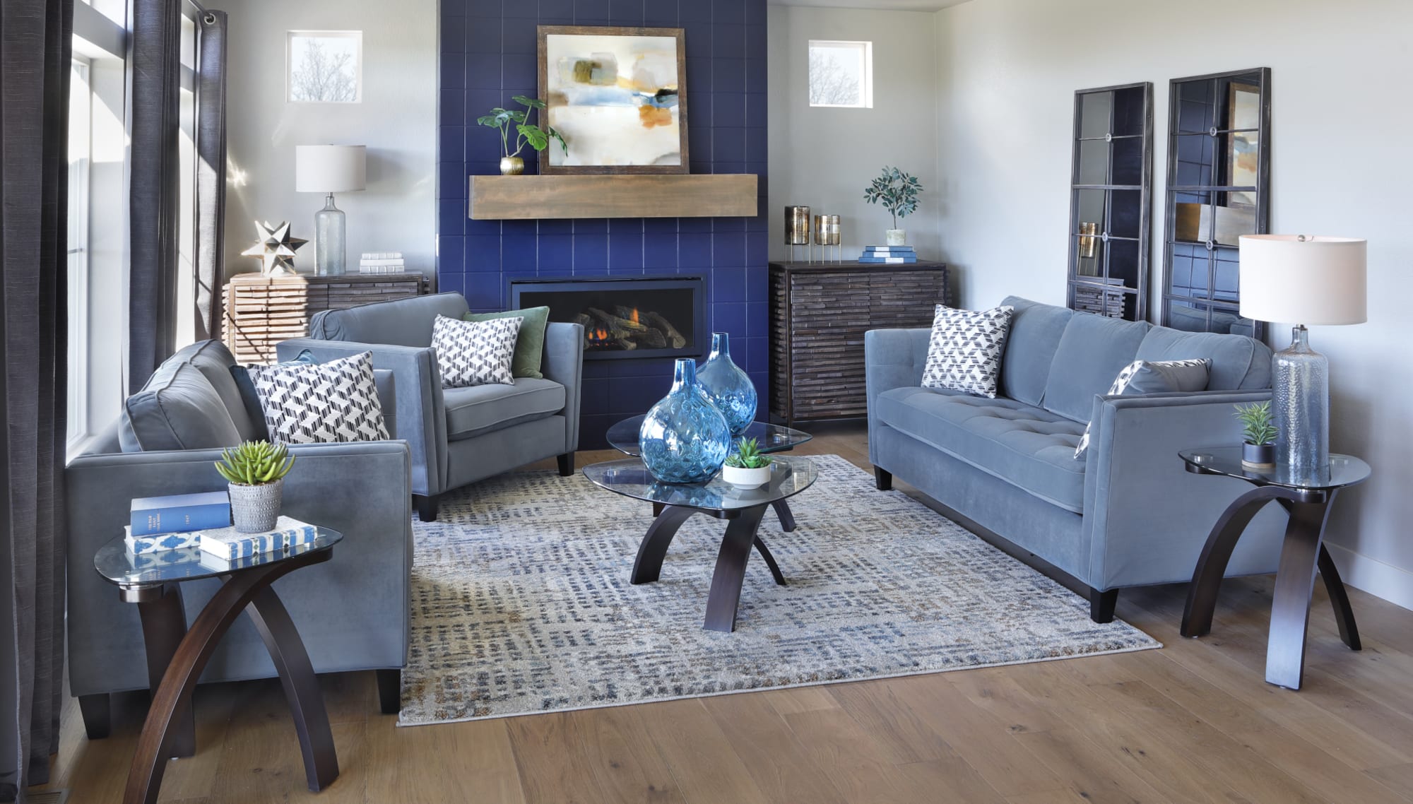 Cornflower Blue Vista sofa set is featured in a living room with a dark blue fireplace.