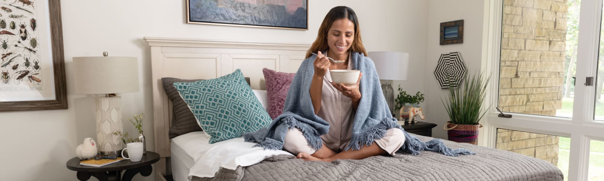 Woman eating cereal on Bonn Storage Bed