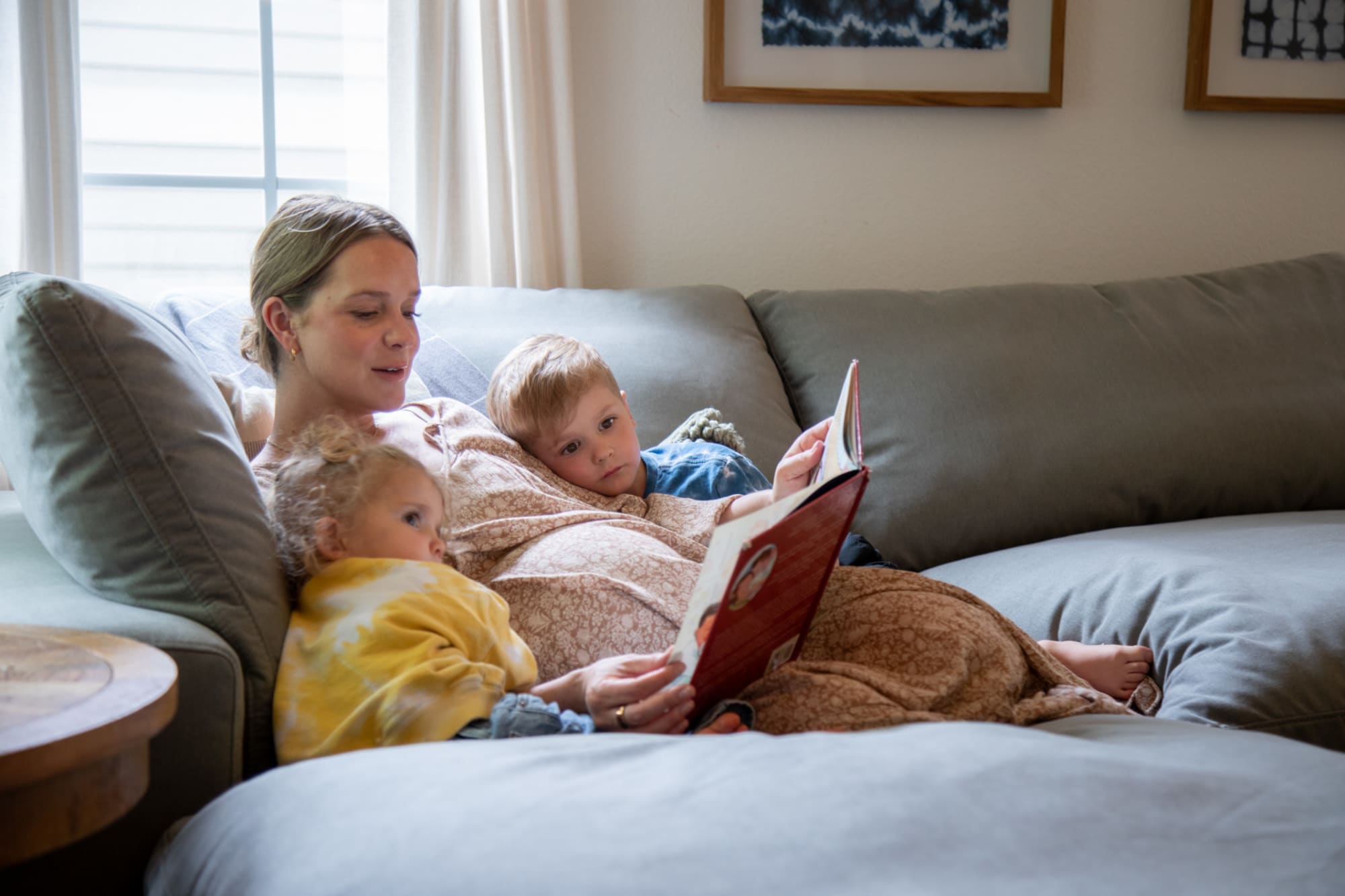 A family reading together atop a modern modular sectional